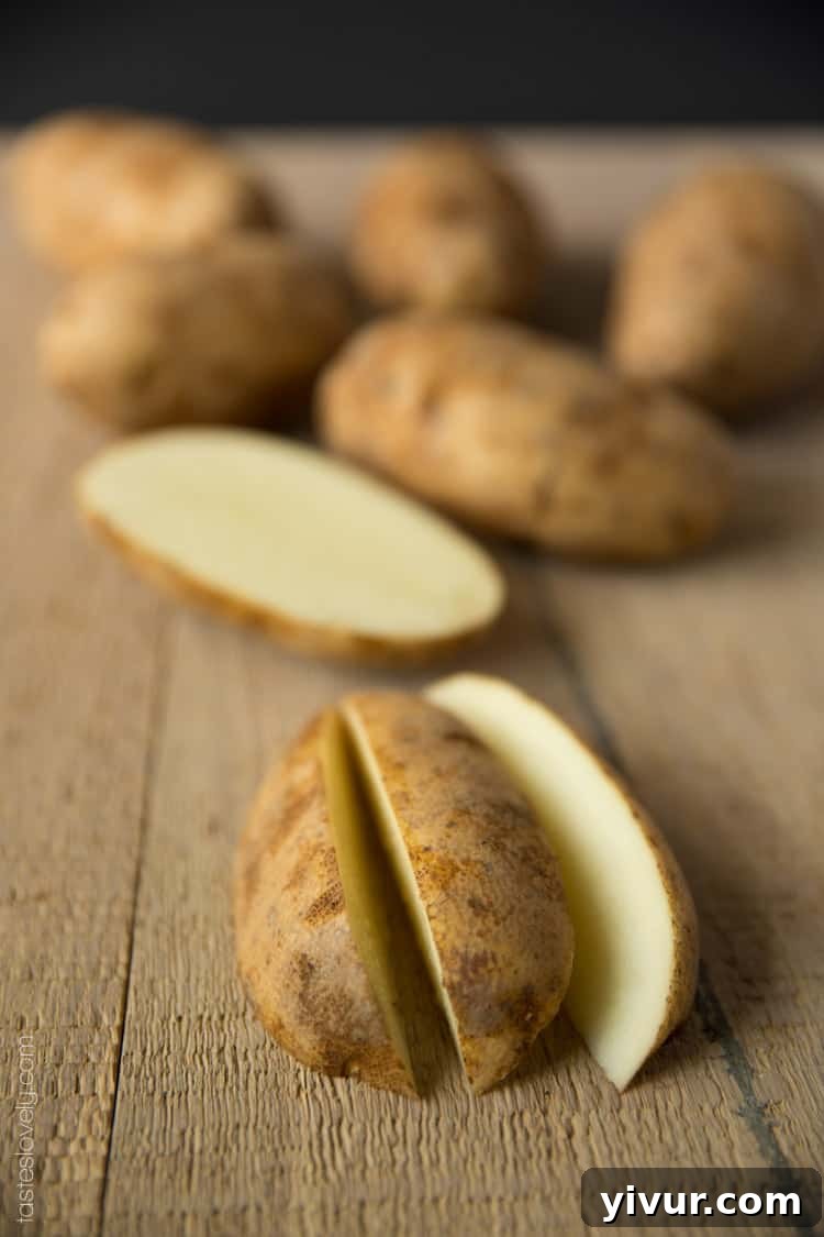 Perfectly Roasted Potato Wedges 4 Hands preparing fresh russet potatoes, cutting them into ideal wedge shapes for baking