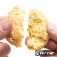 Close-up of a stack of fluffy keto biscuits with a golden crust.