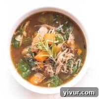 Whole30 + Keto Tuscan Chicken Soup in a bowl with a spoon