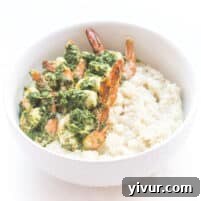 Close-up of perfectly cooked chimichurri shrimp on a bed of cauliflower risotto, ready to be served.