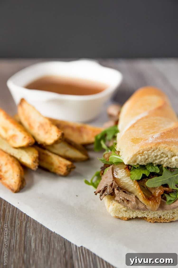 Ultimate Beef Dip Sandwich with Gruyere and Sweet Grilled Onions 5 Another mouth-watering view of the beef dip sandwich, highlighting its golden-brown baguette and savory fillings.