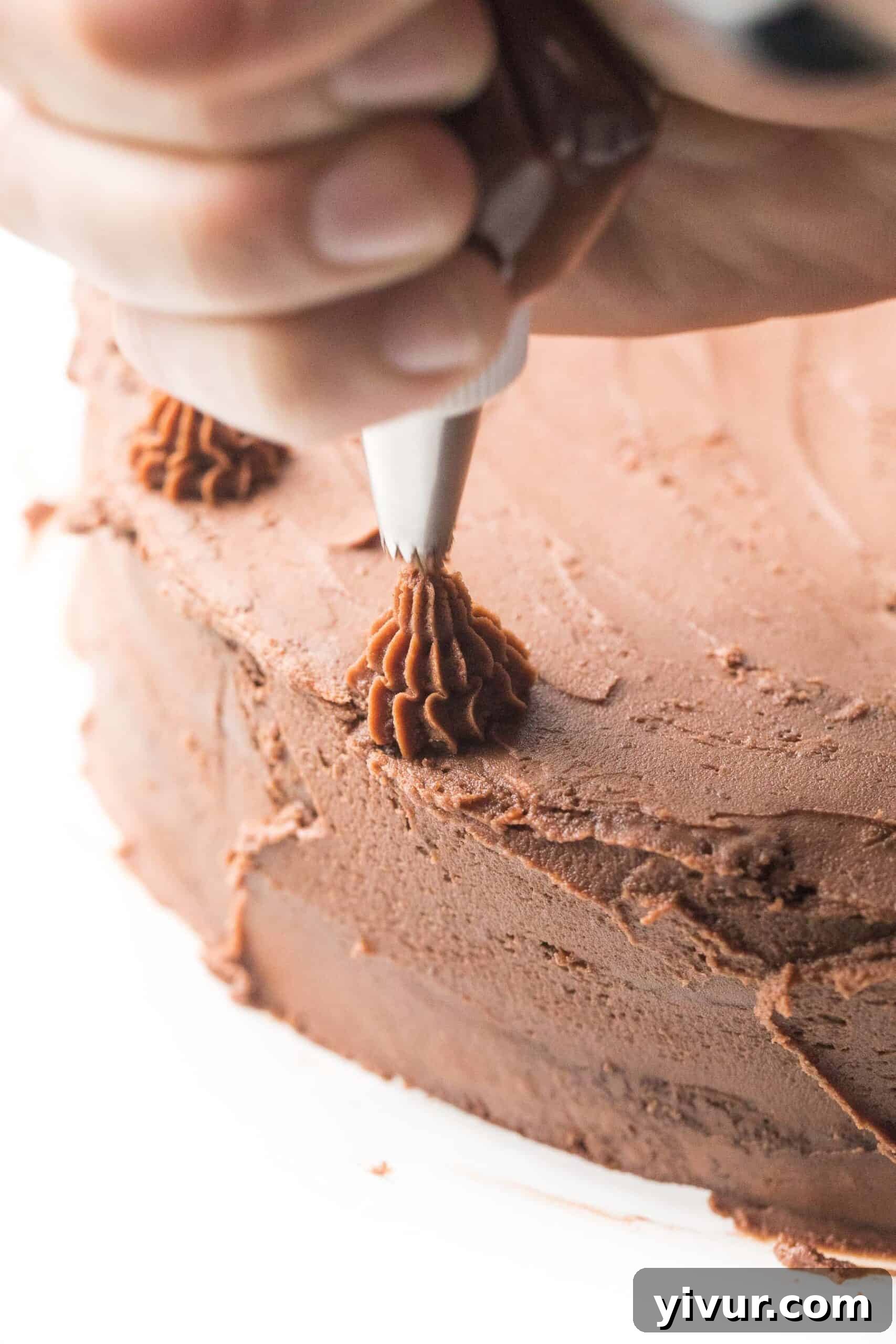 Creamy Keto Dairy Free Mint Chocolate Frosting 3 Piping chocolate frosting onto a cake