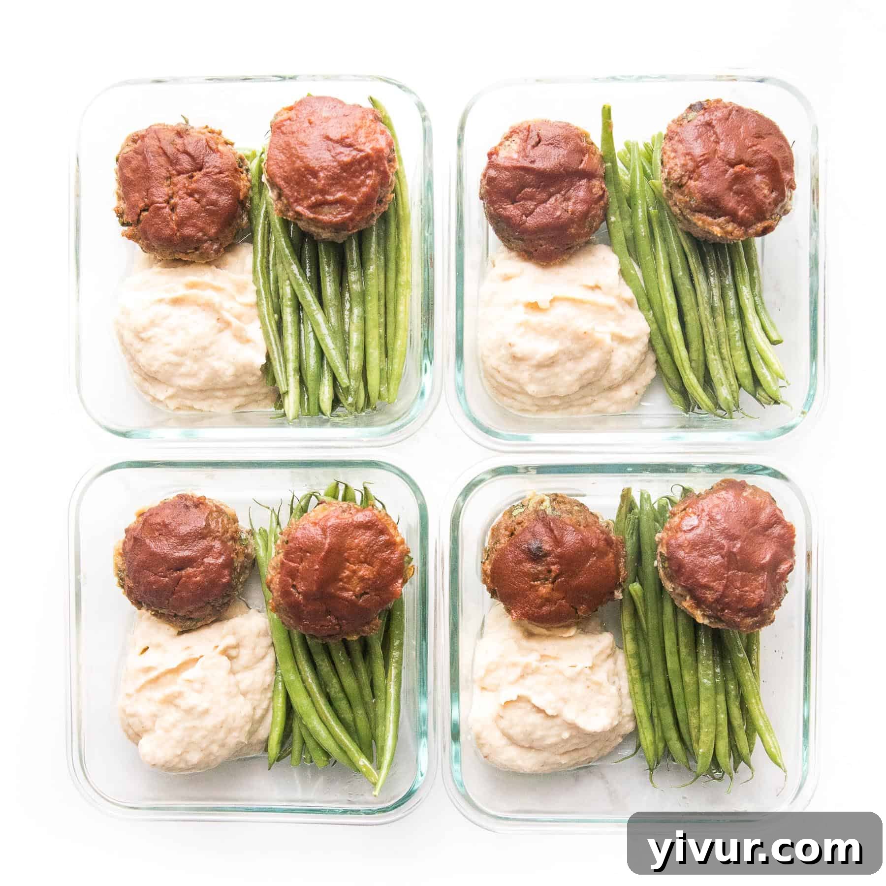Quick Keto Meatloaf Muffin Bites 6 Keto mini meatloaf muffins with ketchup, green beans, and mashed cauliflower perfectly packed in a meal prep container, ready for a healthy lunch.