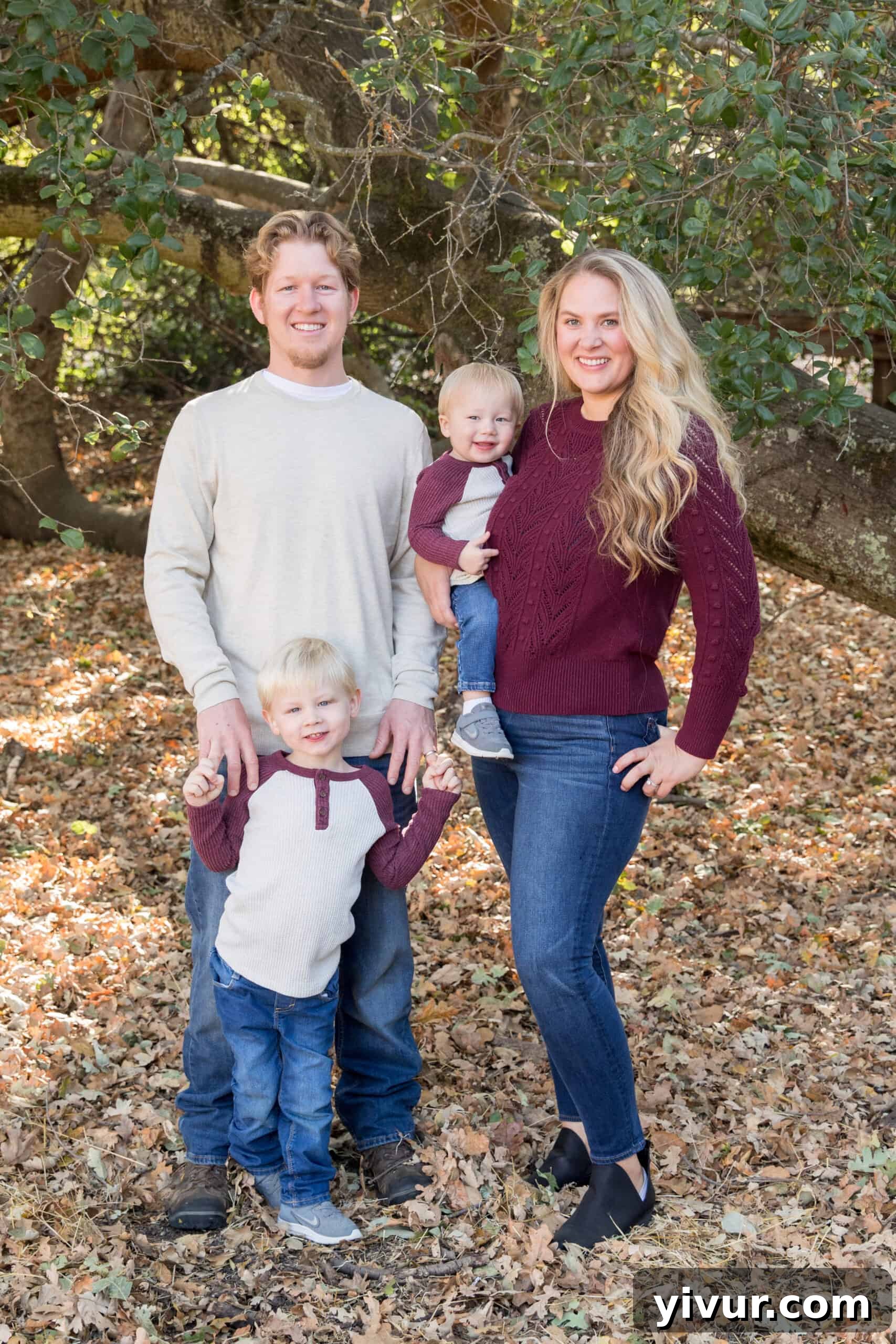 A heartwarming family portrait for Christmas 2019, featuring parents and two young toddlers in festive attire, spreading holiday cheer.