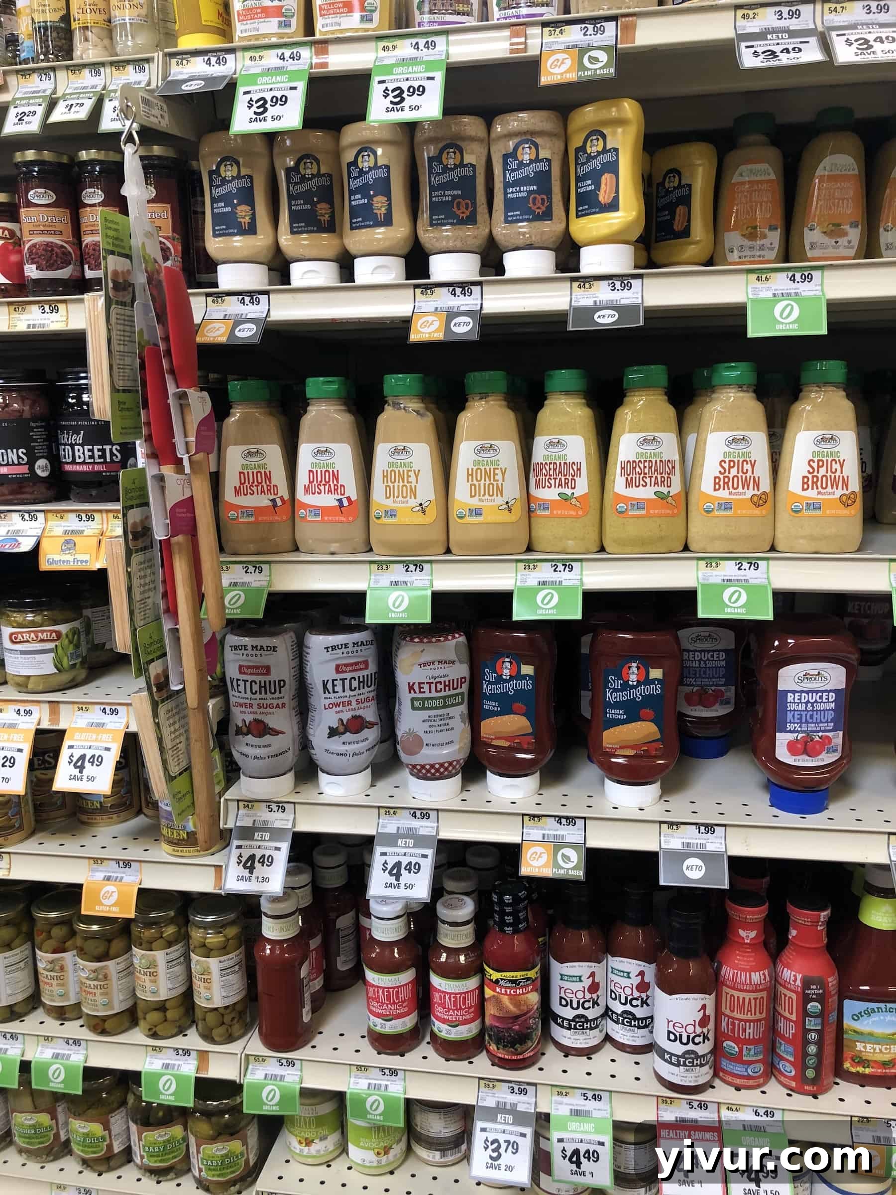 A display of various keto-friendly condiments and specialty ingredients at Sprouts, including healthy oils and sauces.