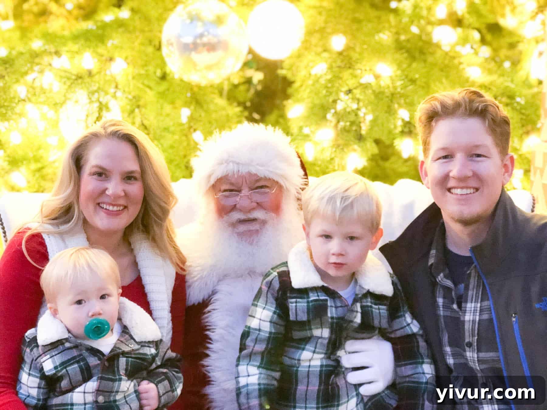 A child happily riding on a seal-shaped skating aid at an outdoor ice rink.