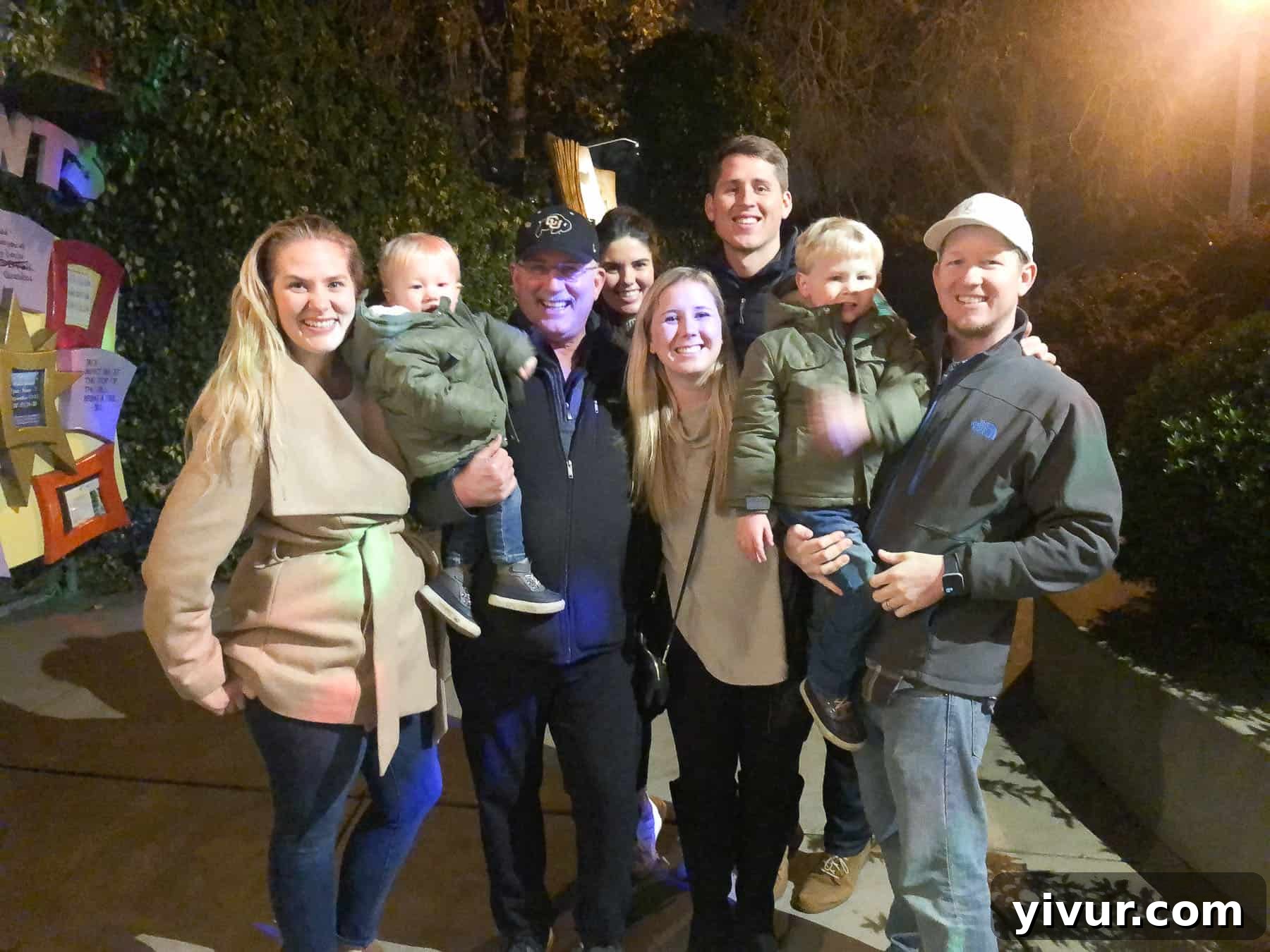 A family enjoying a festive Christmas light display at Fairyland.
