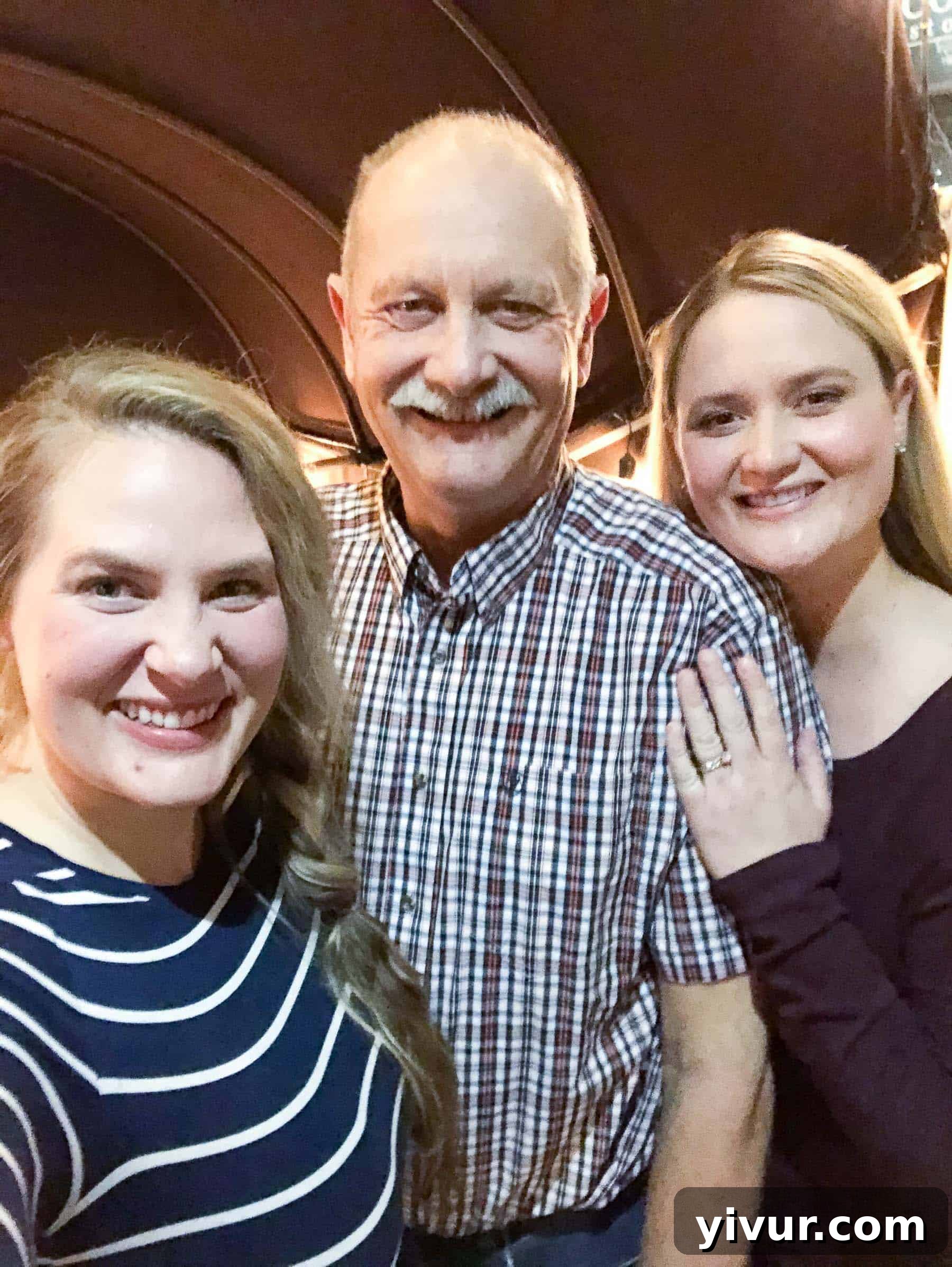 A daughter and her father smiling during a special father-daughter date night.