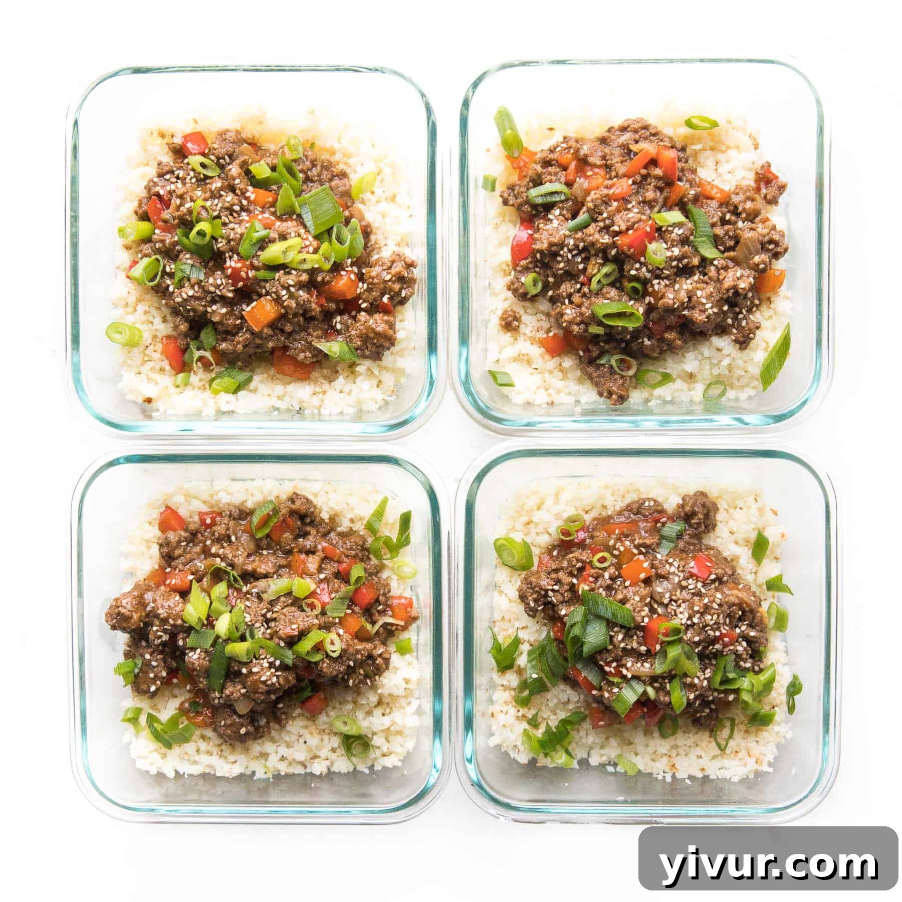 Umami-Rich Whole30 Keto Asian Beef Bowls 5 A perfectly portioned Whole30 + Keto Asian Beef Bowl, complete with ground beef, bell peppers, and green onions over cauliflower rice, neatly packed in a clear meal prep container. Ready for a healthy lunch!