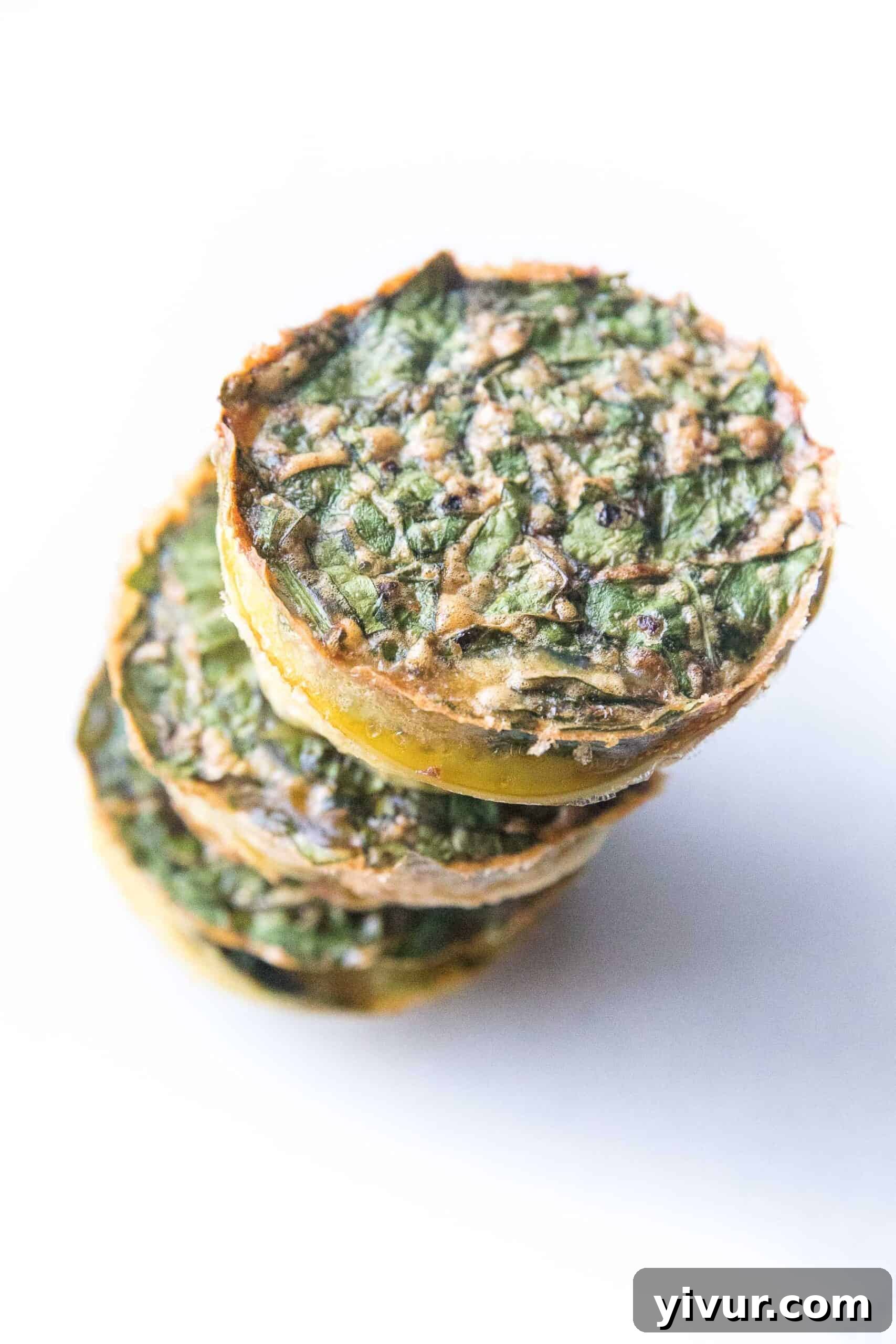 Freshly baked Whole30 and Keto friendly spinach egg muffins in a muffin pan, ready for a healthy breakfast.