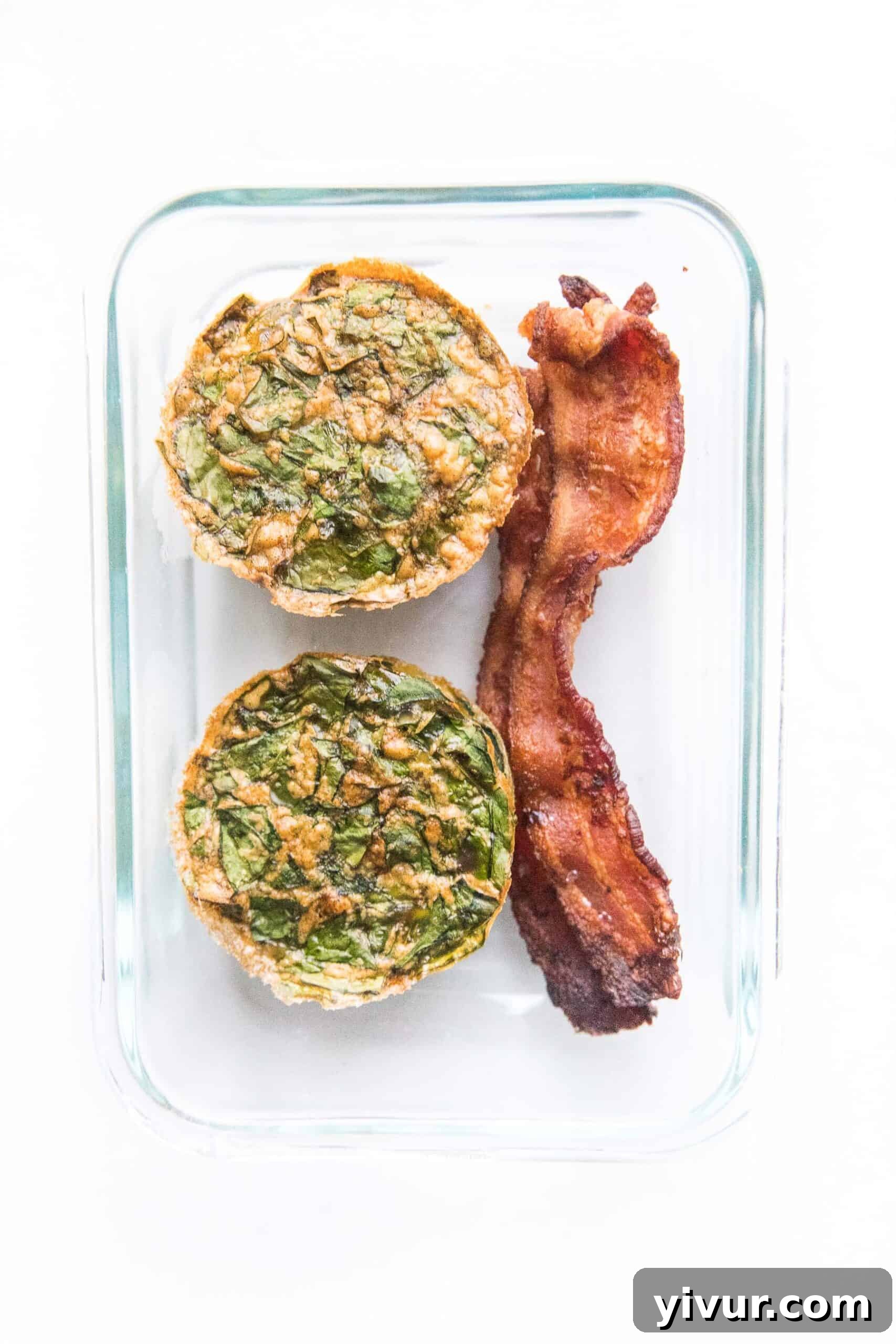 Close-up of a single spinach egg muffin, showing its fluffy texture and vibrant green spinach, highlighting its grab-and-go appeal.
