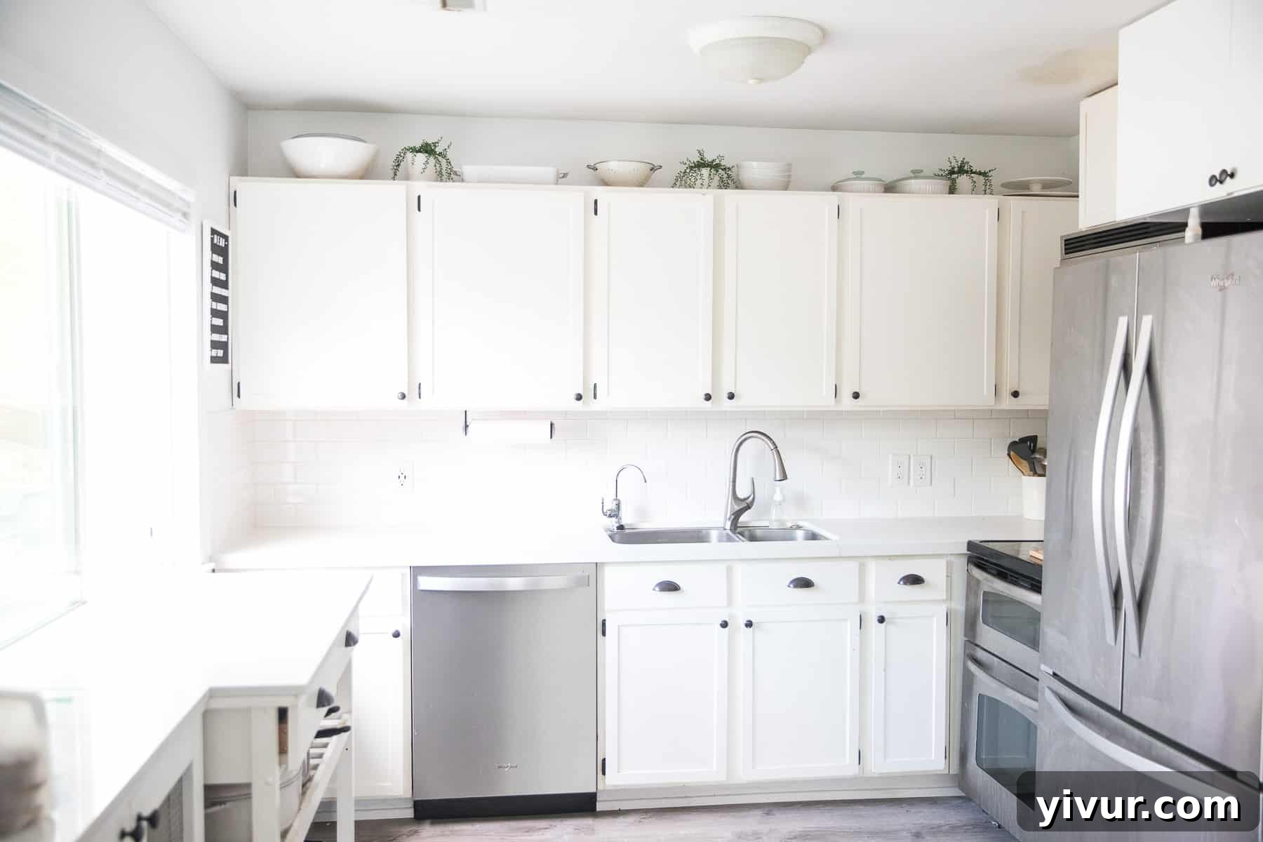 Step Inside Our 700 Sq Ft Tiny Home 2 Modern white tiny home kitchen with quartz countertops and organized storage
