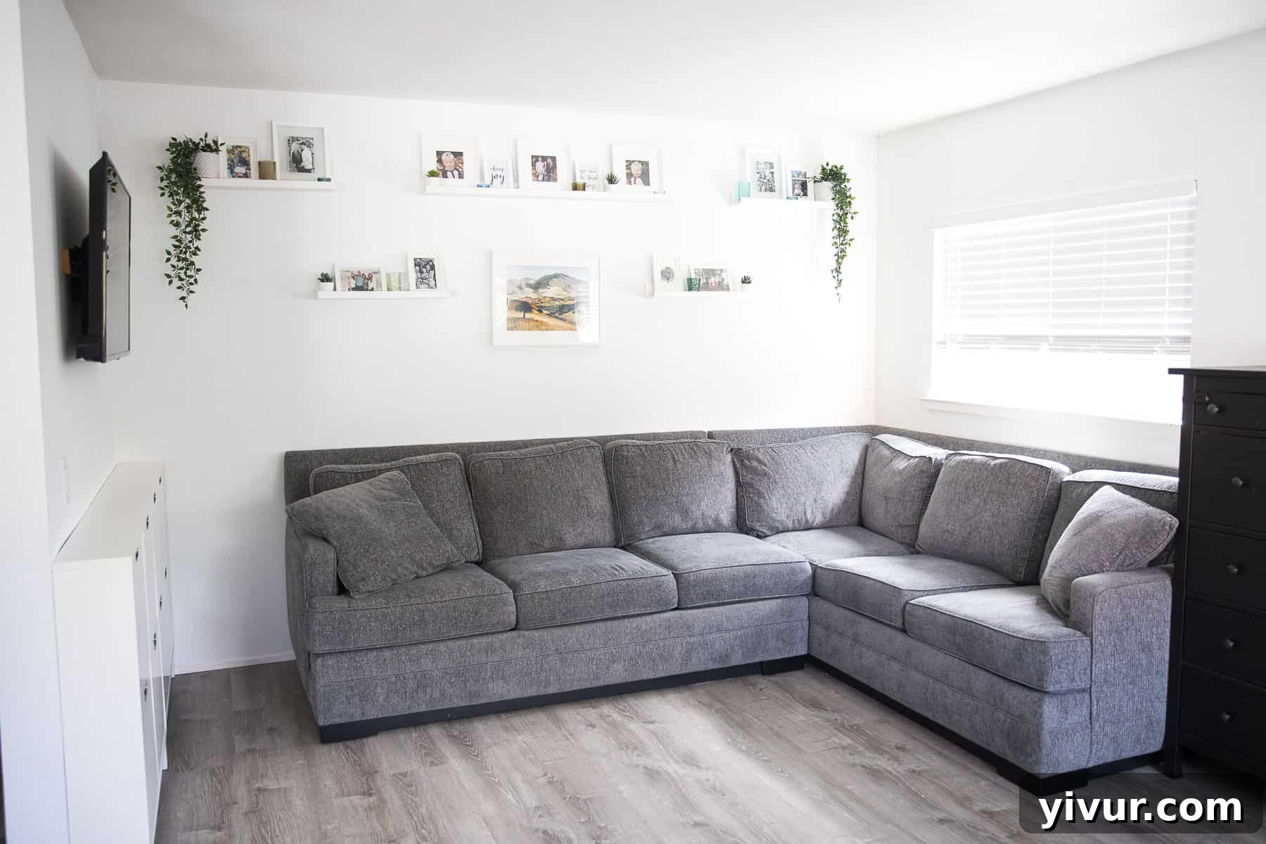 Step Inside Our 700 Sq Ft Tiny Home 4 Photo gallery wall in a tiny home with pictures, plants, and candles