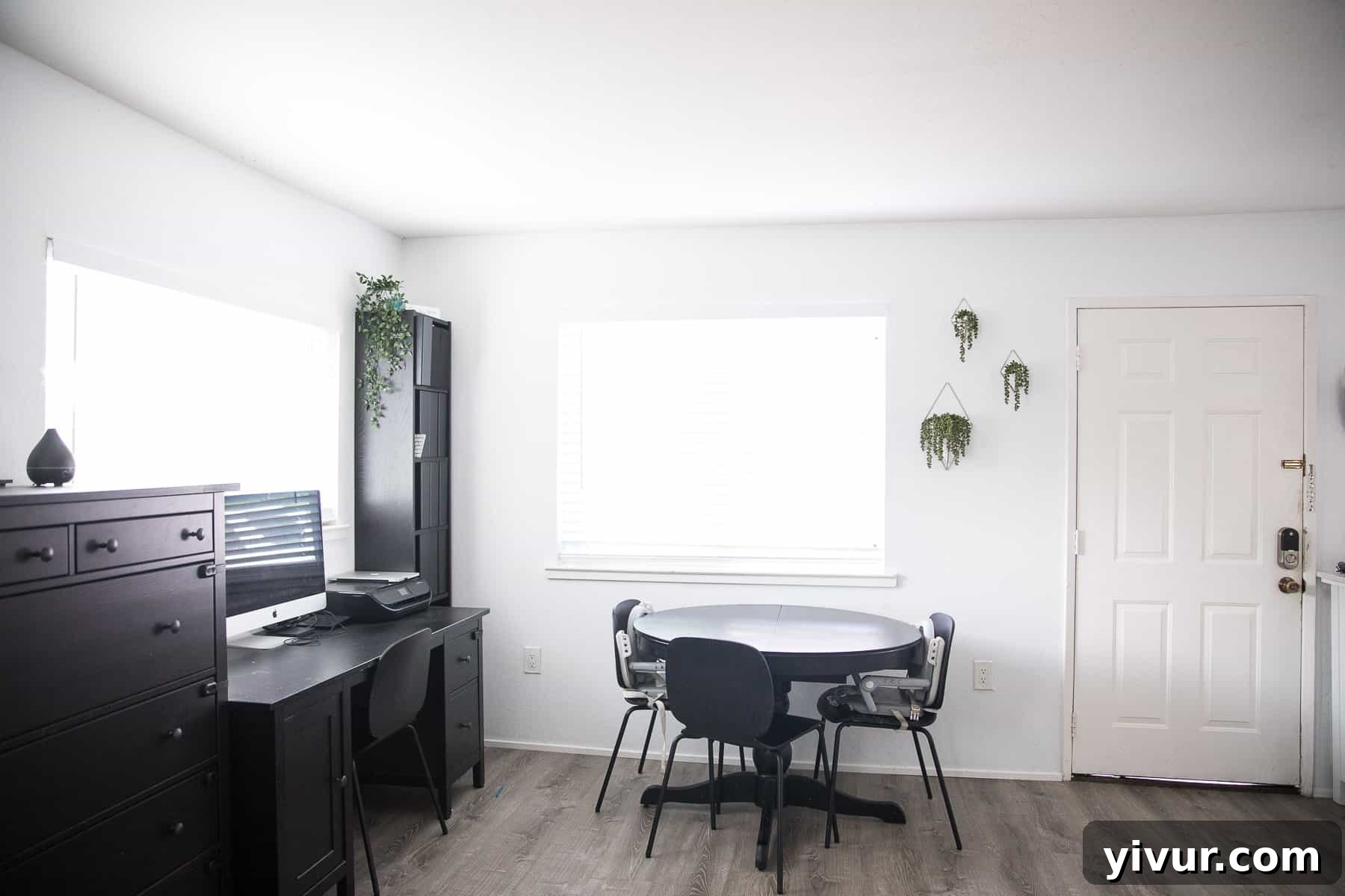Step Inside Our 700 Sq Ft Tiny Home 5 Tiny home dining room with an extendable black table, chairs, and hanging plants