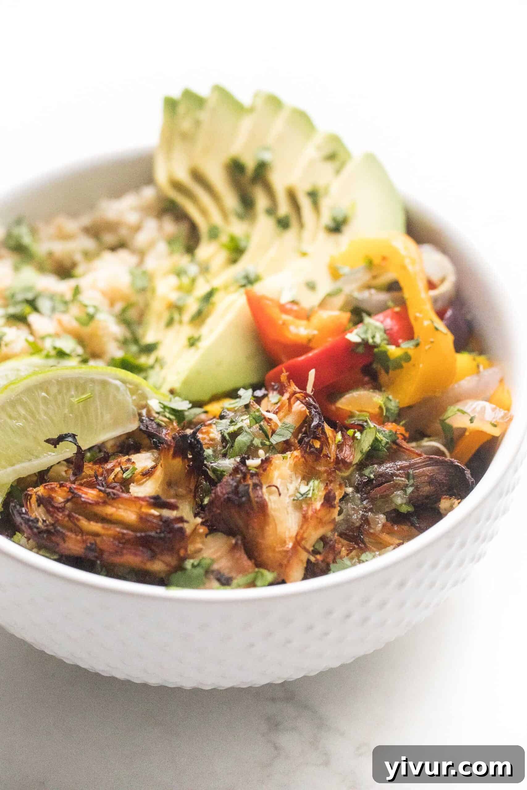 Crispy verde chicken burrito bowl on a white background, highlighting its versatility