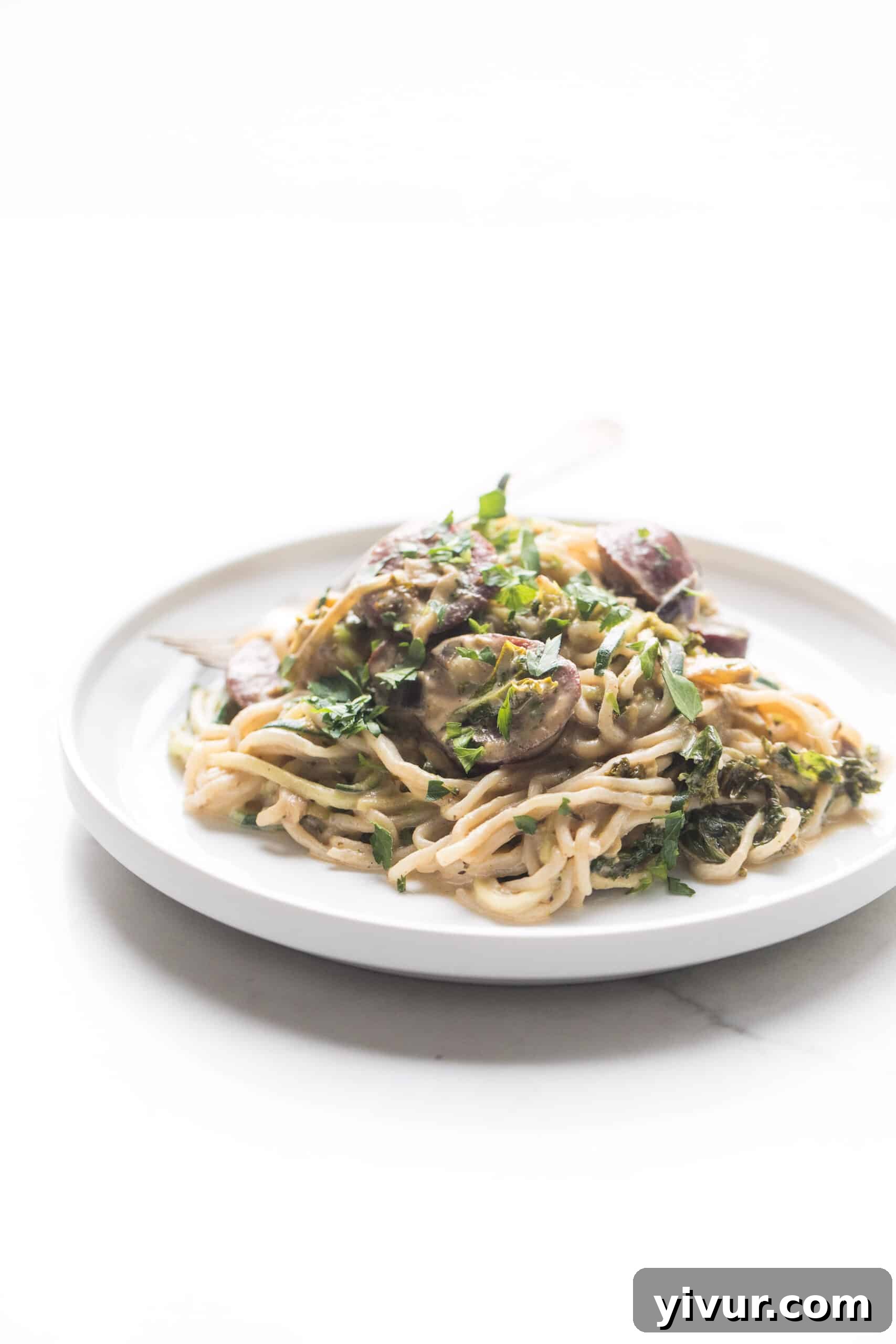 creamy pasta elegantly plated on a white dish, garnished and ready for a close-up