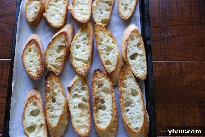Bruschetta-13: Toasted crostinis on a baking sheet