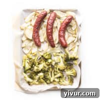 sausage, roasted fennel and broccoli on a white plate and background