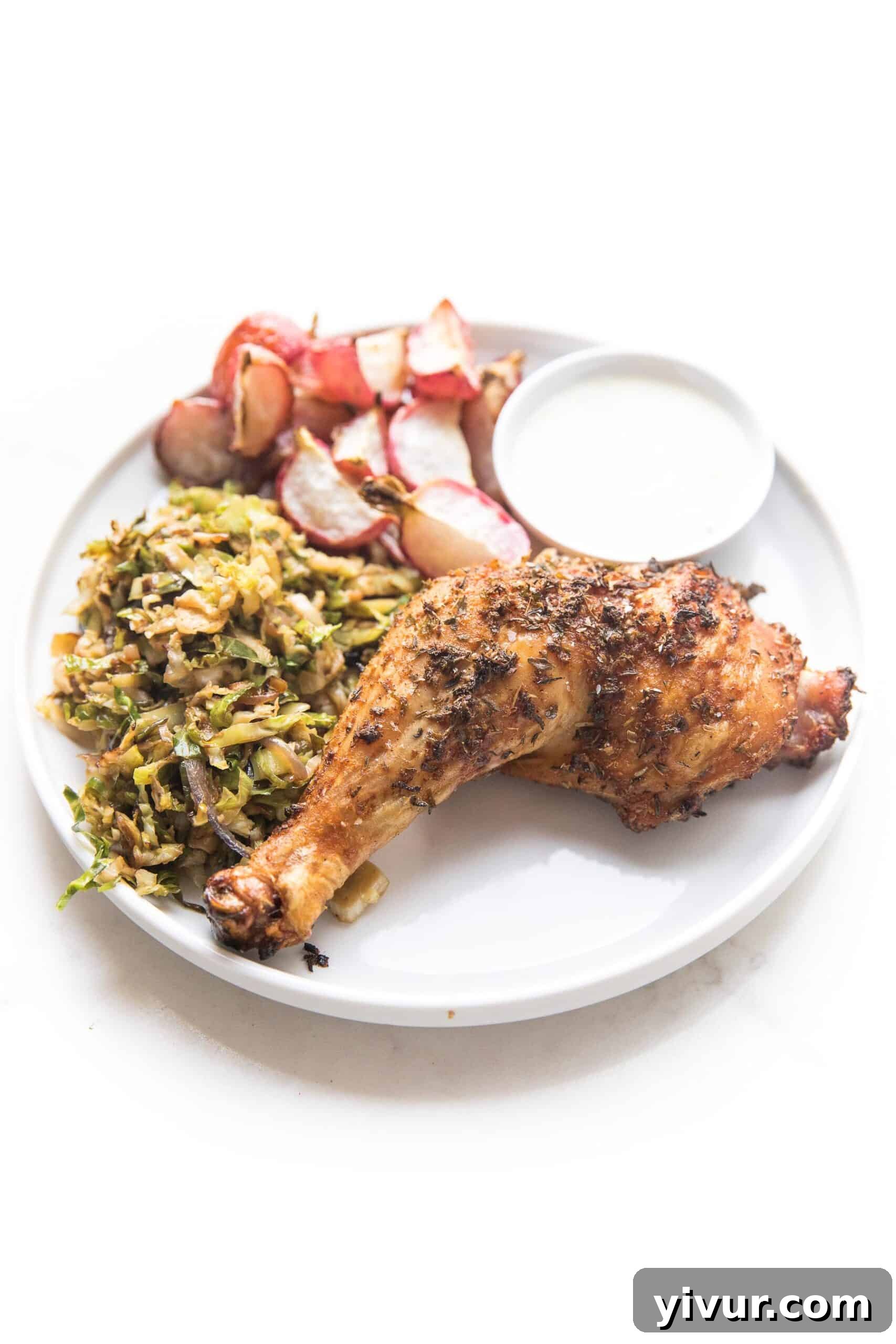 Grilled Spatchcock Blackened Chicken presented on a white plate with complementary sides.