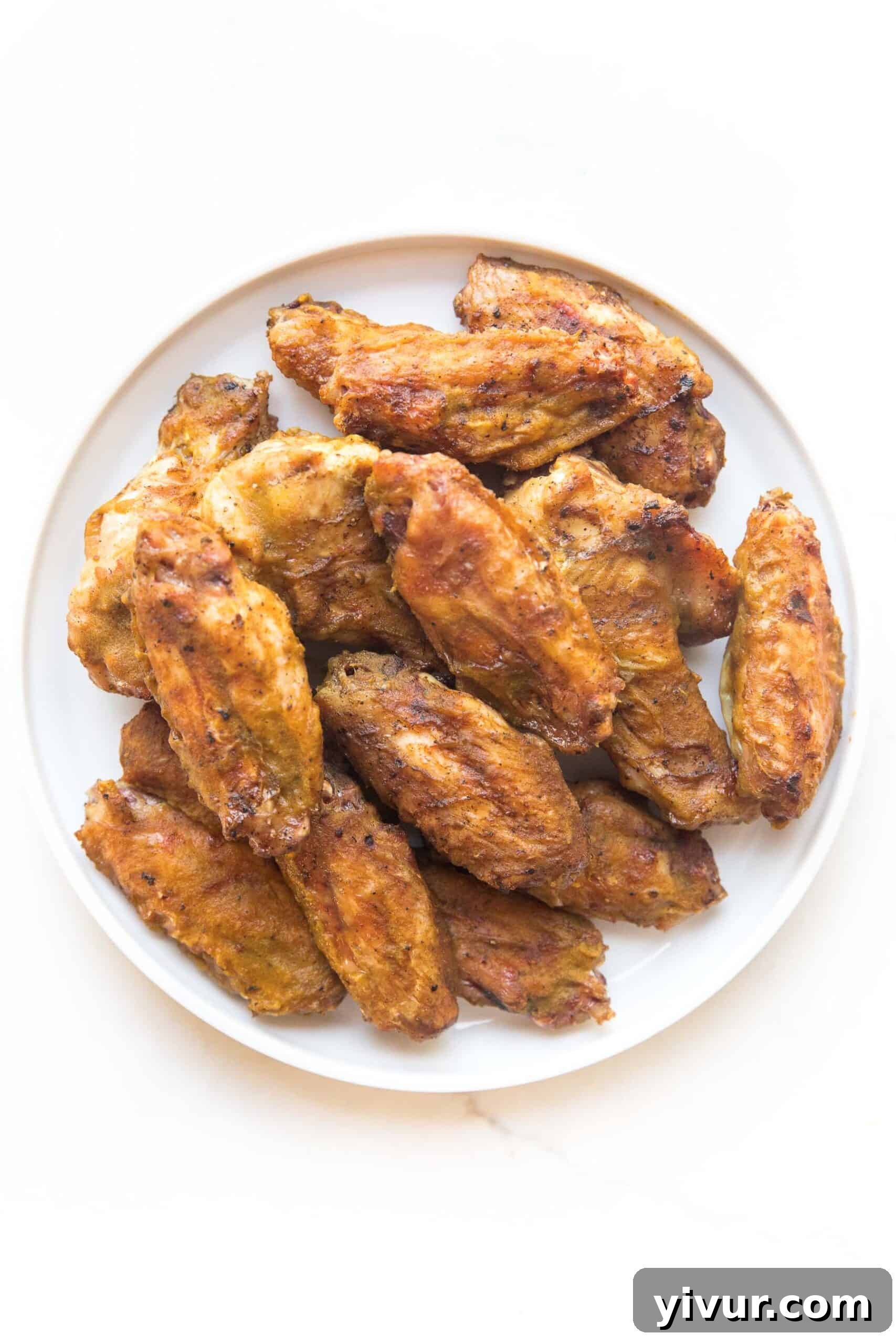BBQ CHICKEN WINGS ON A WHITE PLATE