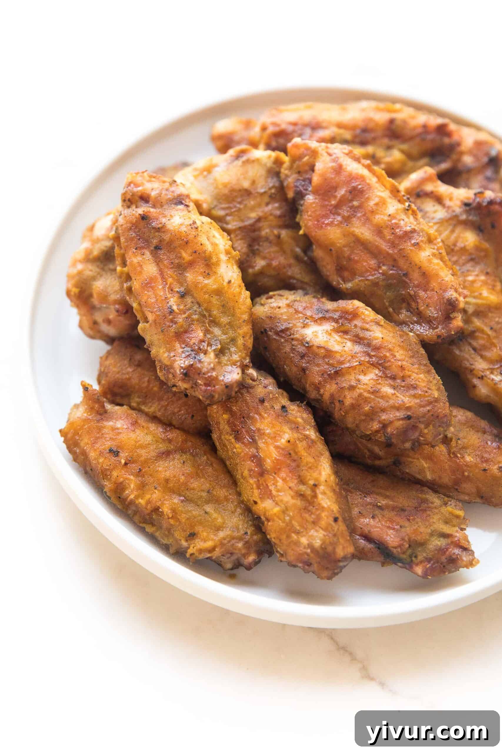 BBQ CHICKEN WINGS ON A WHITE PLATE