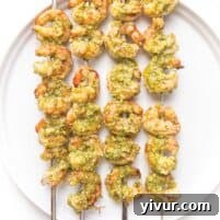 pesto shrimp kabobs on a white plate