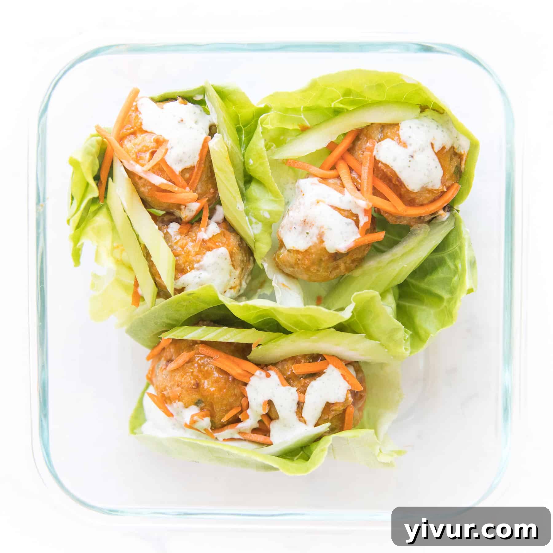 meal prep keto buffalo turkey meatball lettuce wraps in a glass meal prep container