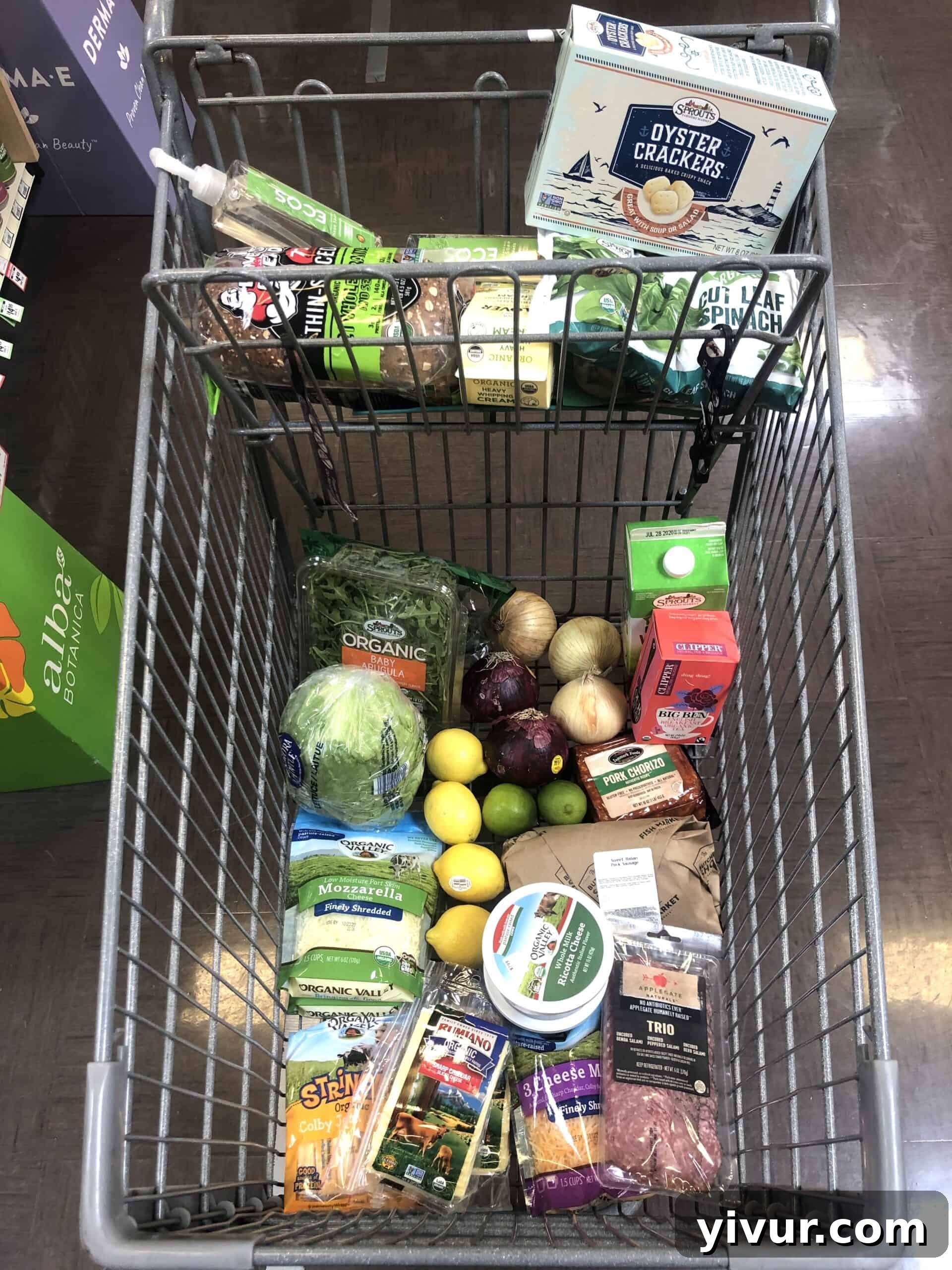 A fresh grocery haul from Sprouts, showcasing an assortment of organic vegetables, leafy greens, colorful fruits, and specialty items.