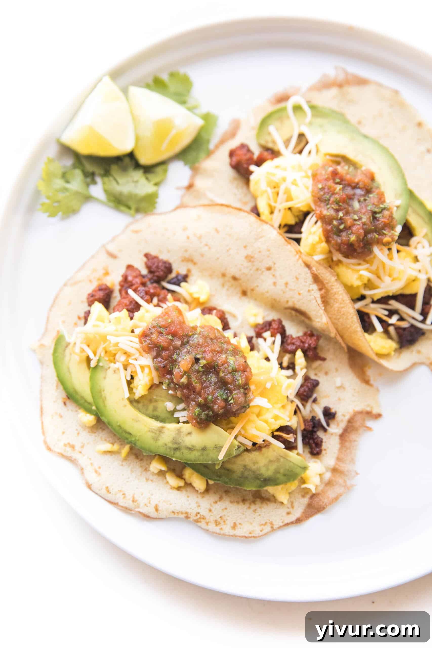 Low-Carb Morning Taco Delights 2 Delicious Keto Breakfast Tacos on a white plate, garnished with fresh toppings