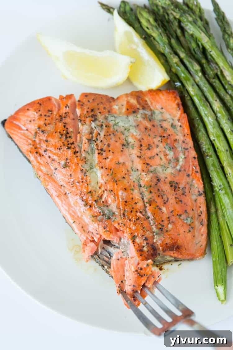 Golden Seared Salmon with Fresh Dill Butter 5 A close-up of a pan-seared salmon fillet, glistening with melted dill butter, highlighting its golden crust and inviting texture.
