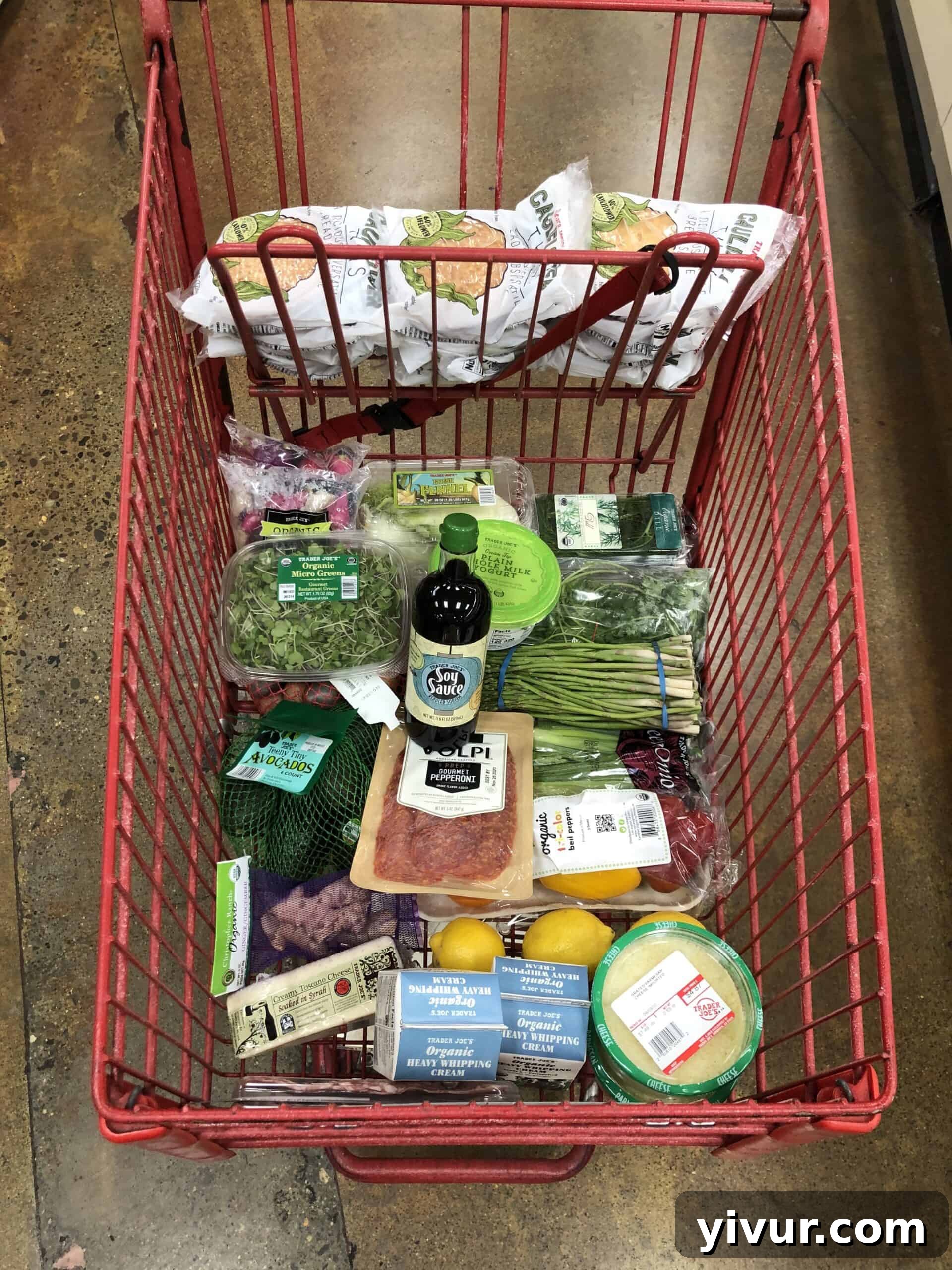 August Keto Meals Week Two 3 A detailed photograph of a Trader Joe's keto grocery haul, displaying various low-carb items, produce, and pantry staples.