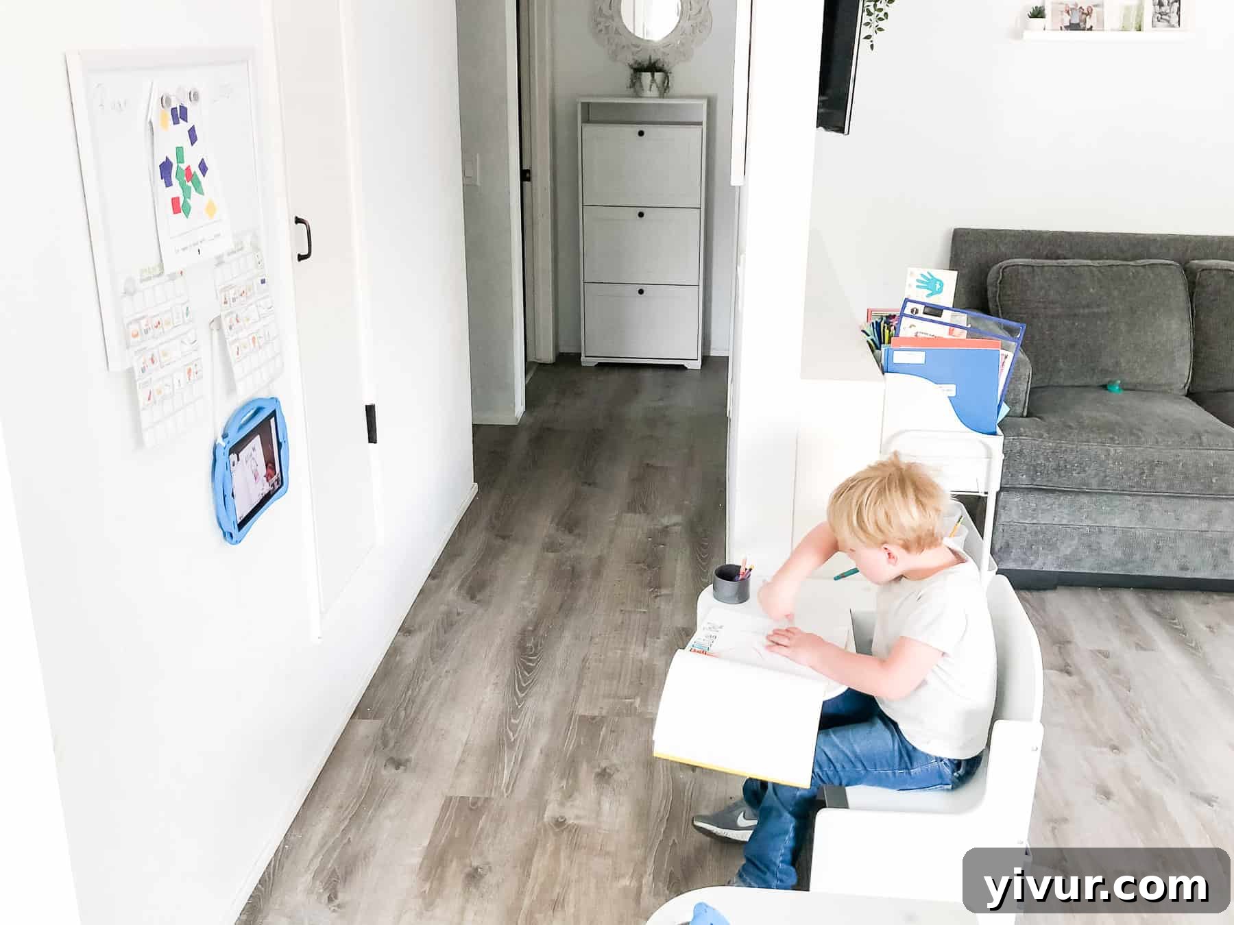 Our Virtual Learning Hub 4 Kindergarten virtual learning desk with a child focused on activities and organized supplies