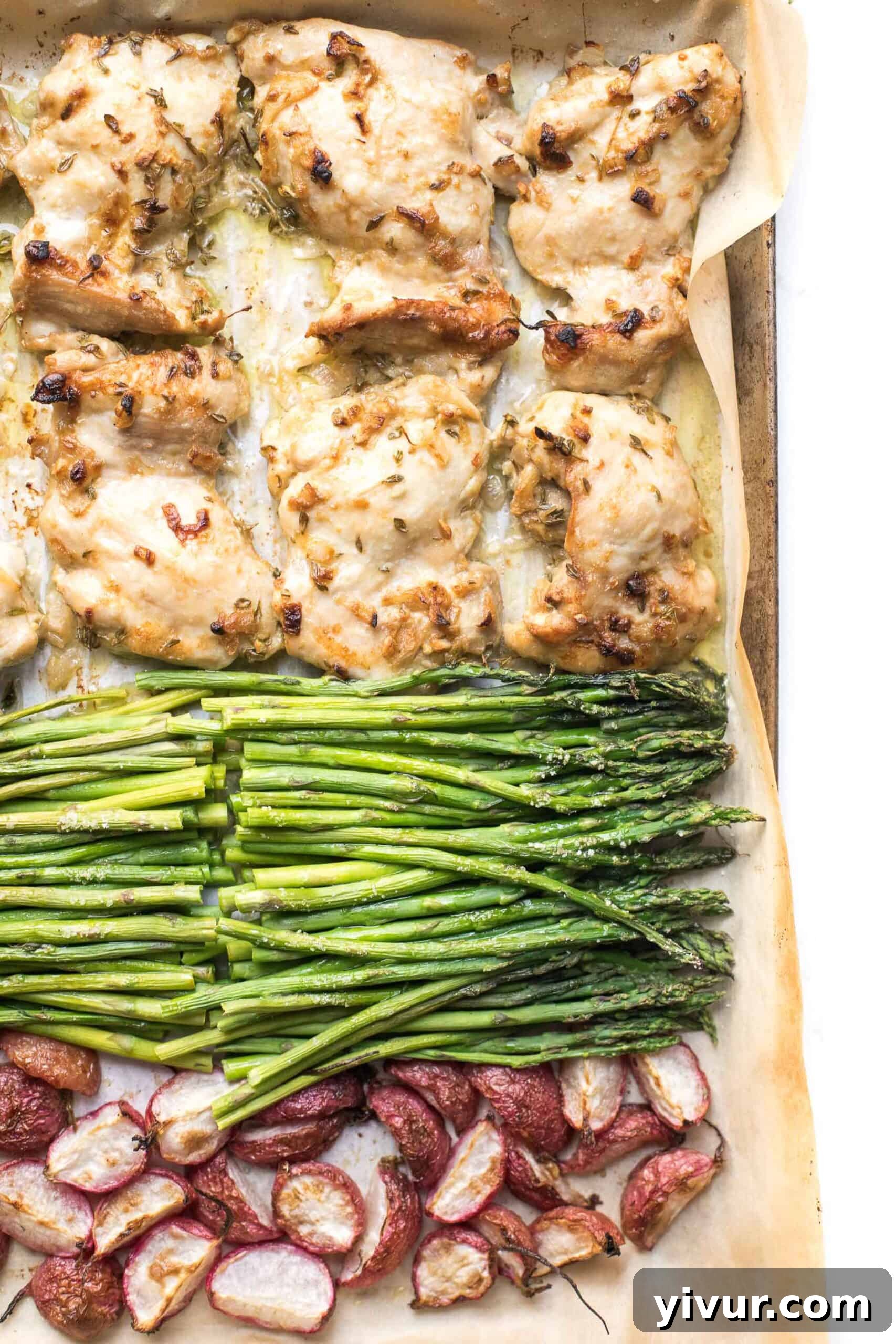 A close-up of the Keto Sheet Pan Dijon Chicken + Radishes, showcasing a perfectly cooked chicken thigh next to tender roasted radishes and crisp asparagus, glistening with marinade.