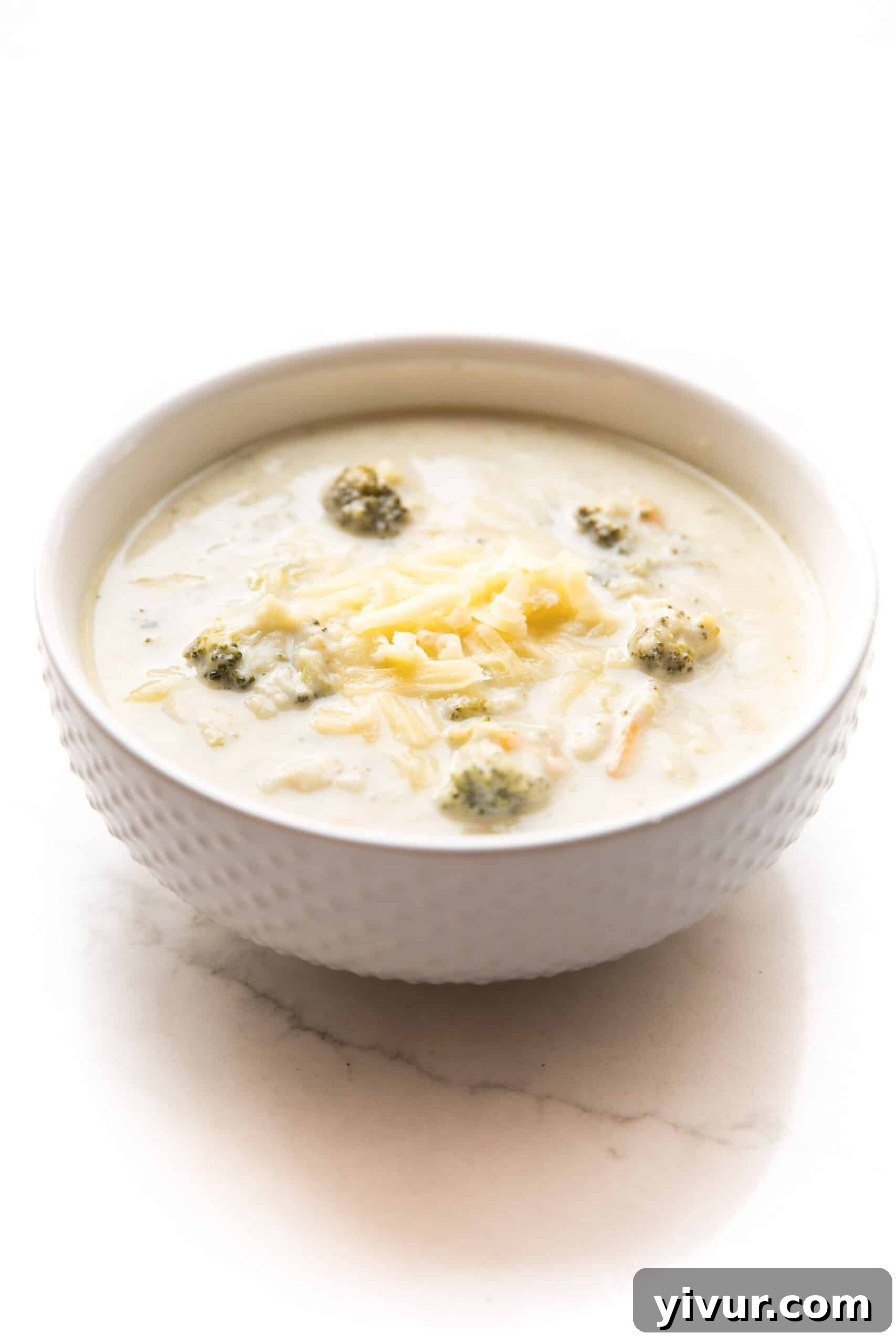 A close-up of a bowl of Instant Pot Keto Broccoli Cheddar Soup, showcasing its creamy texture and rich color.