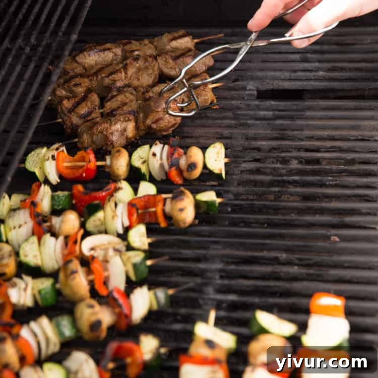 Close-up of freshly grilled steak and vegetable kabobs on a platter, showcasing the beautiful char and vibrant colors