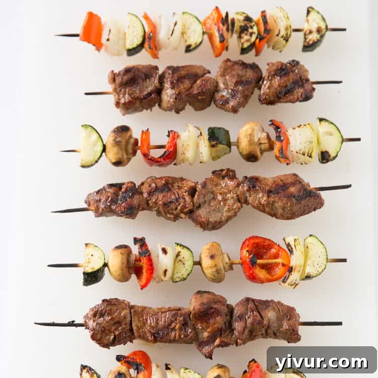Finished grilled steak and vegetable kabobs arranged on skewers, ready to be served, emphasizing healthy eating