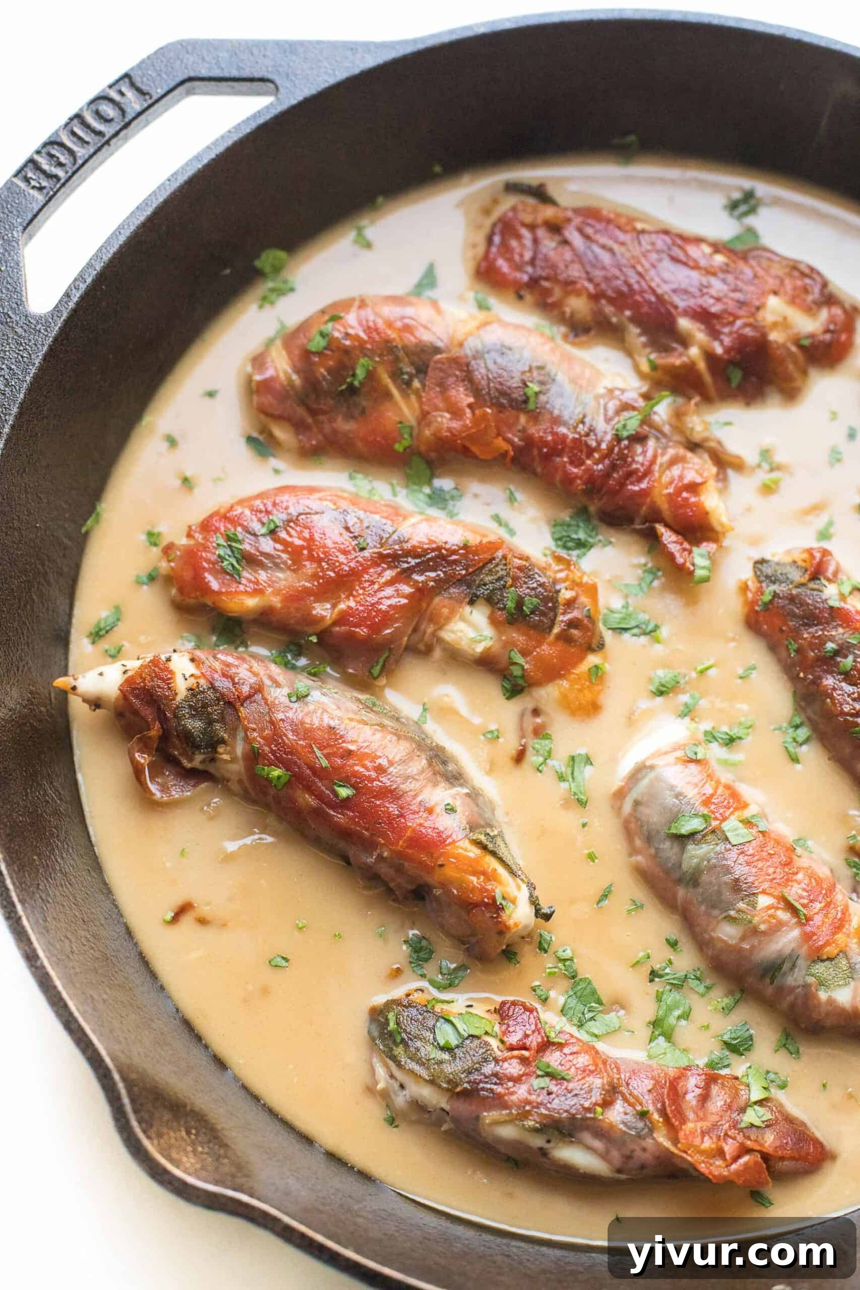 keto + whole30 prosciutto wrapped chicken with creamy apple cider gravy over mashed cauliflower with roasted brussels sprouts in a cast iron skillet