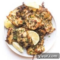 Whole30 + Keto Cilantro Lime Chicken Thighs on a white plate with garnish.