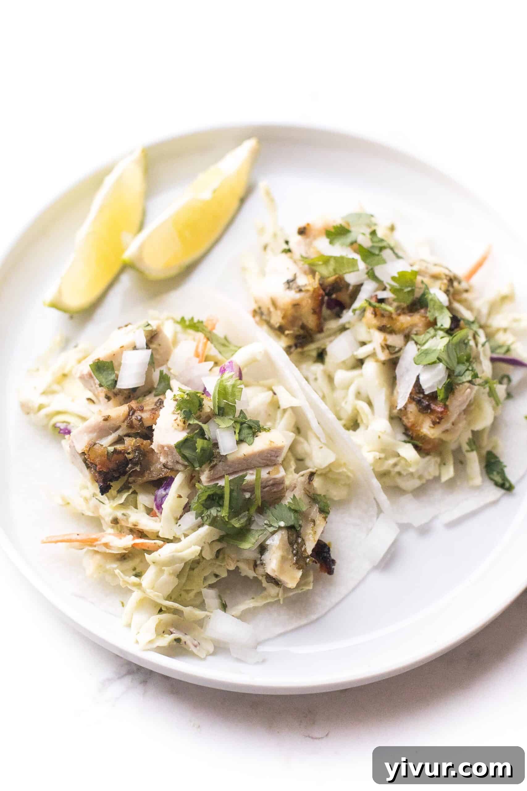 Whole30 + keto cilantro lime chicken tacos with coleslaw on trader joe's jicama wraps