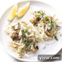 Whole30 + keto cilantro lime chicken tacos with coleslaw on trader joe's jicama wraps