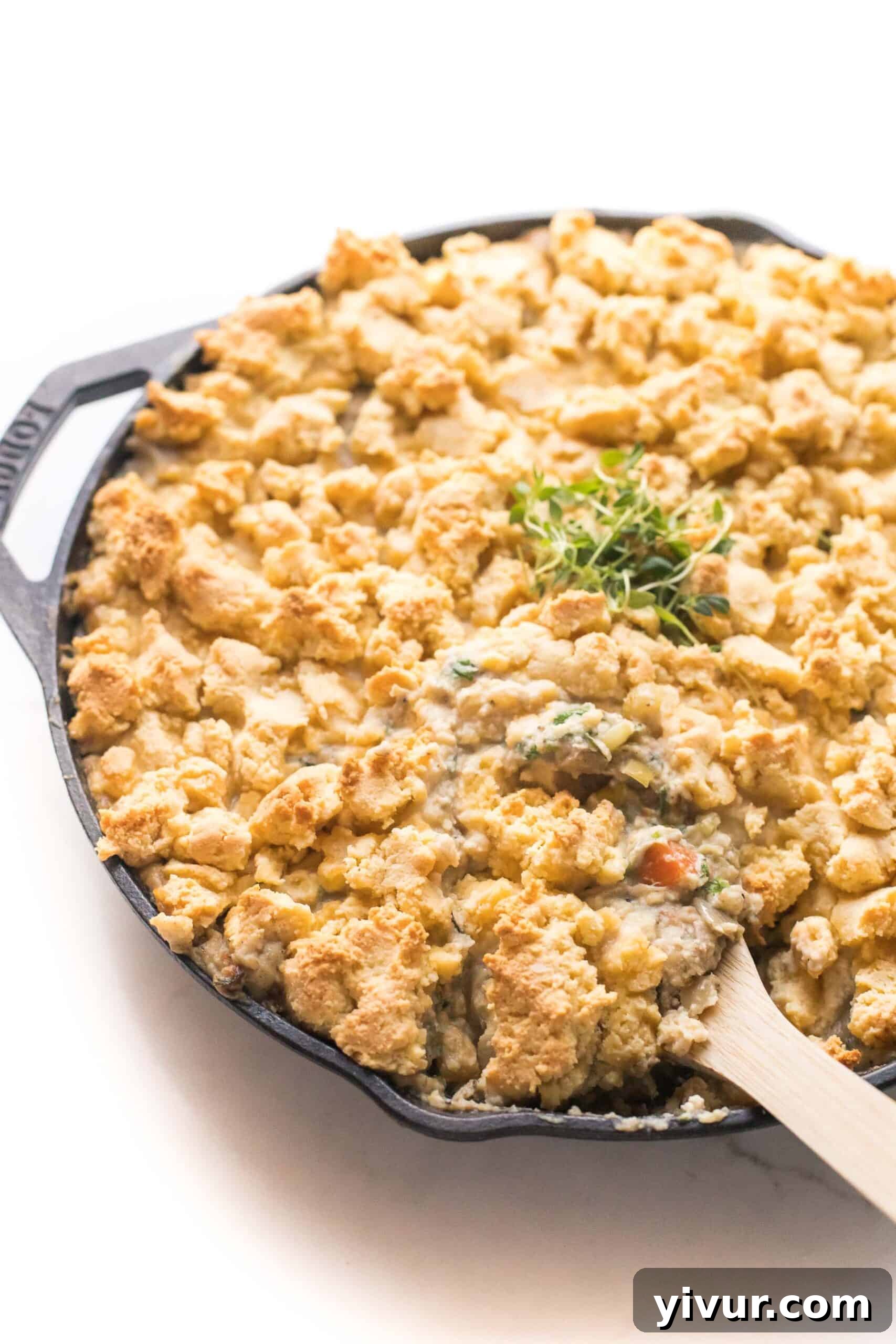 Delicious Keto Chicken Pot Pie Crumble in a cast iron skillet, ready to serve on a white background
