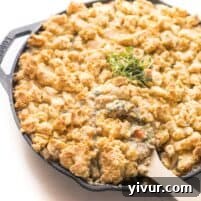 keto chicken pot pie crumble in a cast iron skillet on a white background