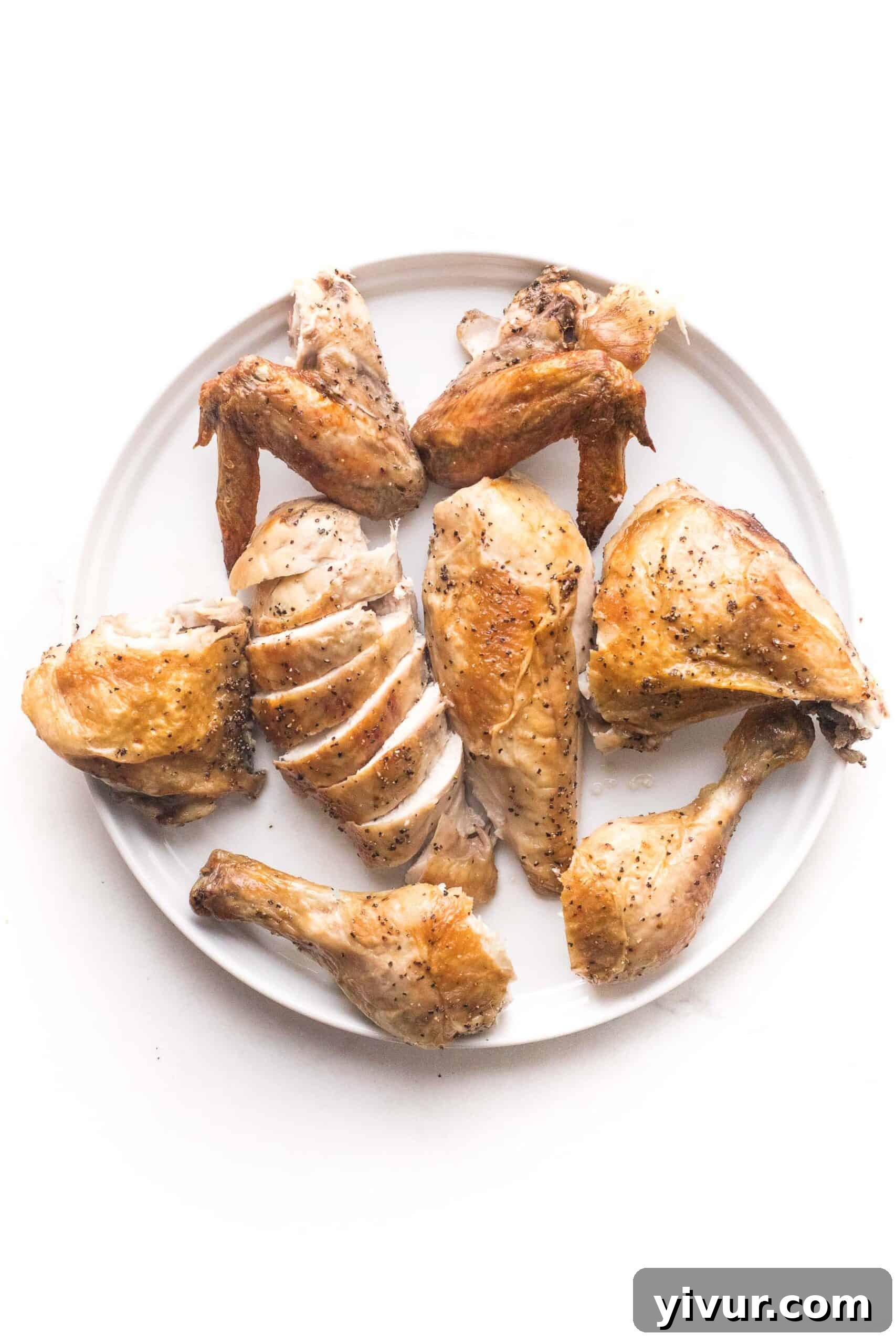Carved spatchcock chicken arranged neatly in 8 pieces on a serving platter