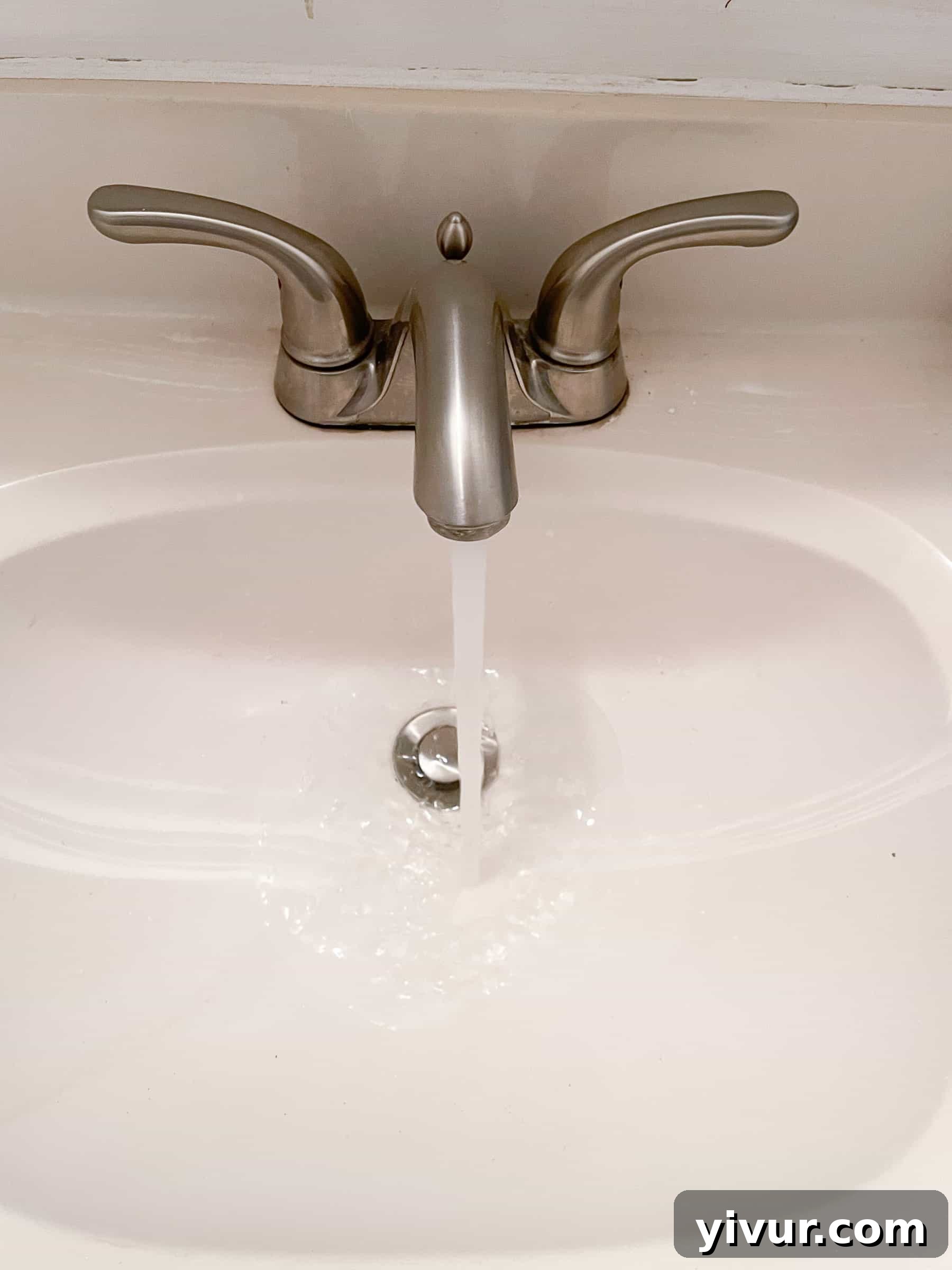 Bathroom sink faucet with broken knobs, water still pouring out