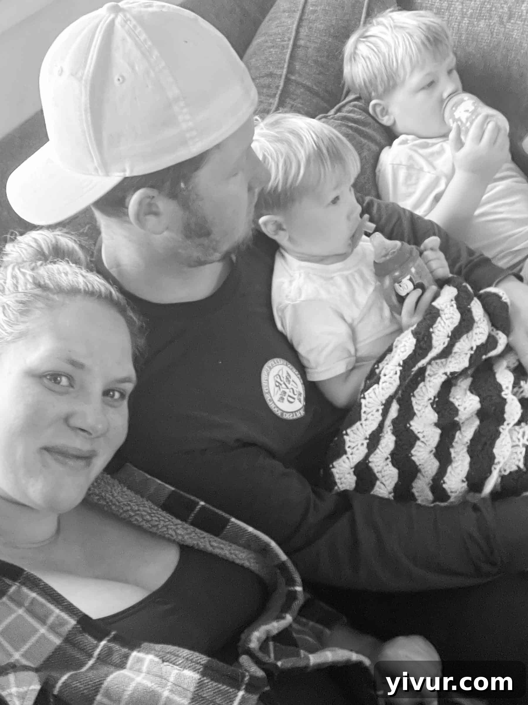 Cozy family photo on the couch, enjoying hot cocoa and cartoons