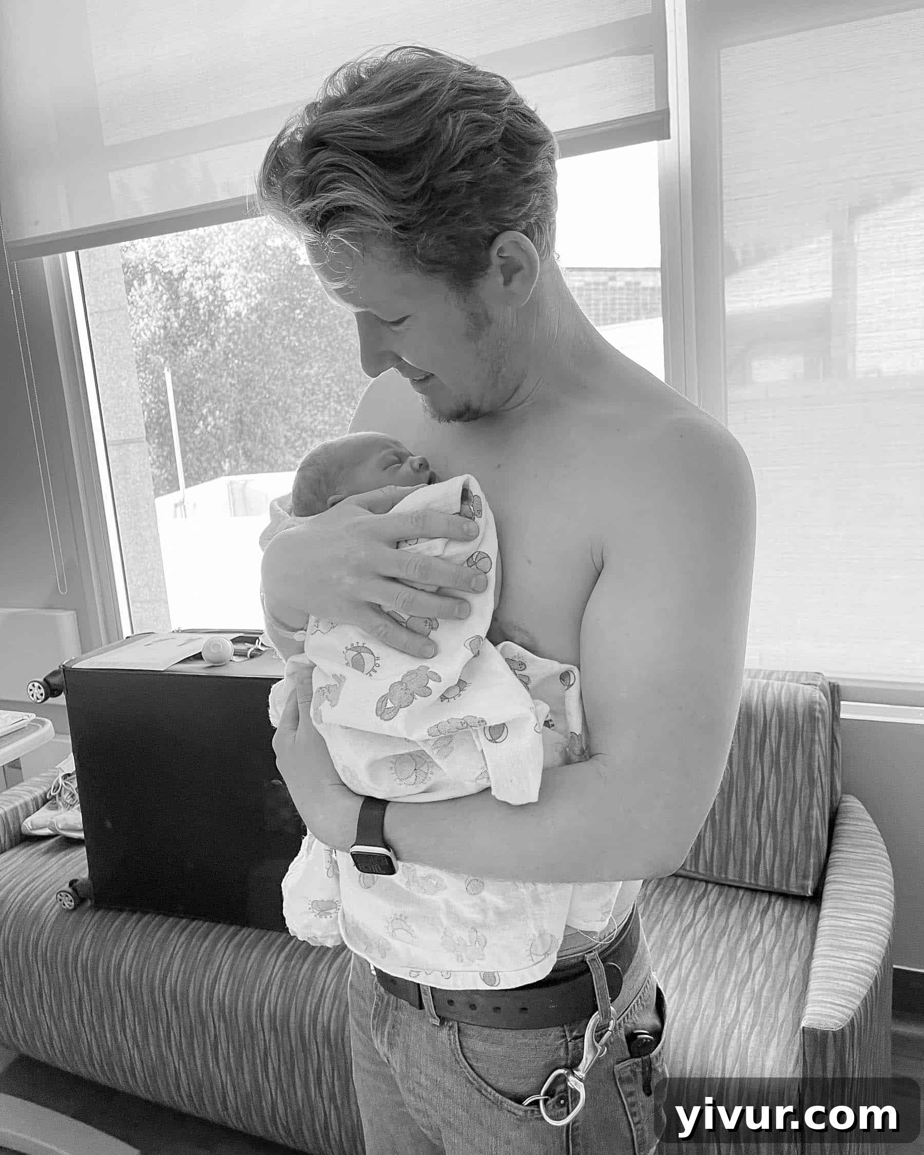 Baby Lucas Shawn wrapped in a blanket, his tiny hands visible.