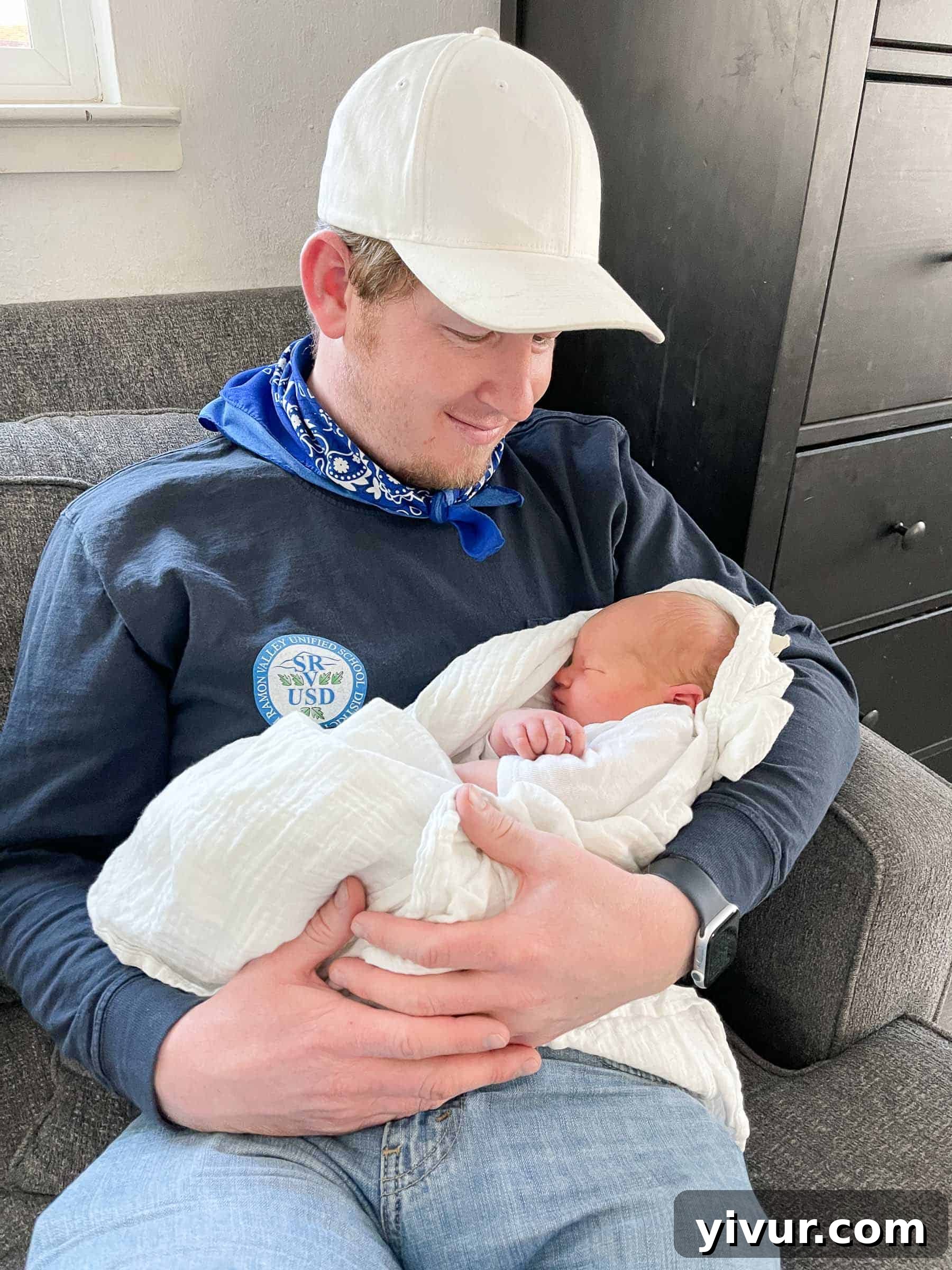 Another heartwarming close-up of newborn Luke, this time capturing his peaceful face as he sleeps, emphasizing his delicate features and serene nature.