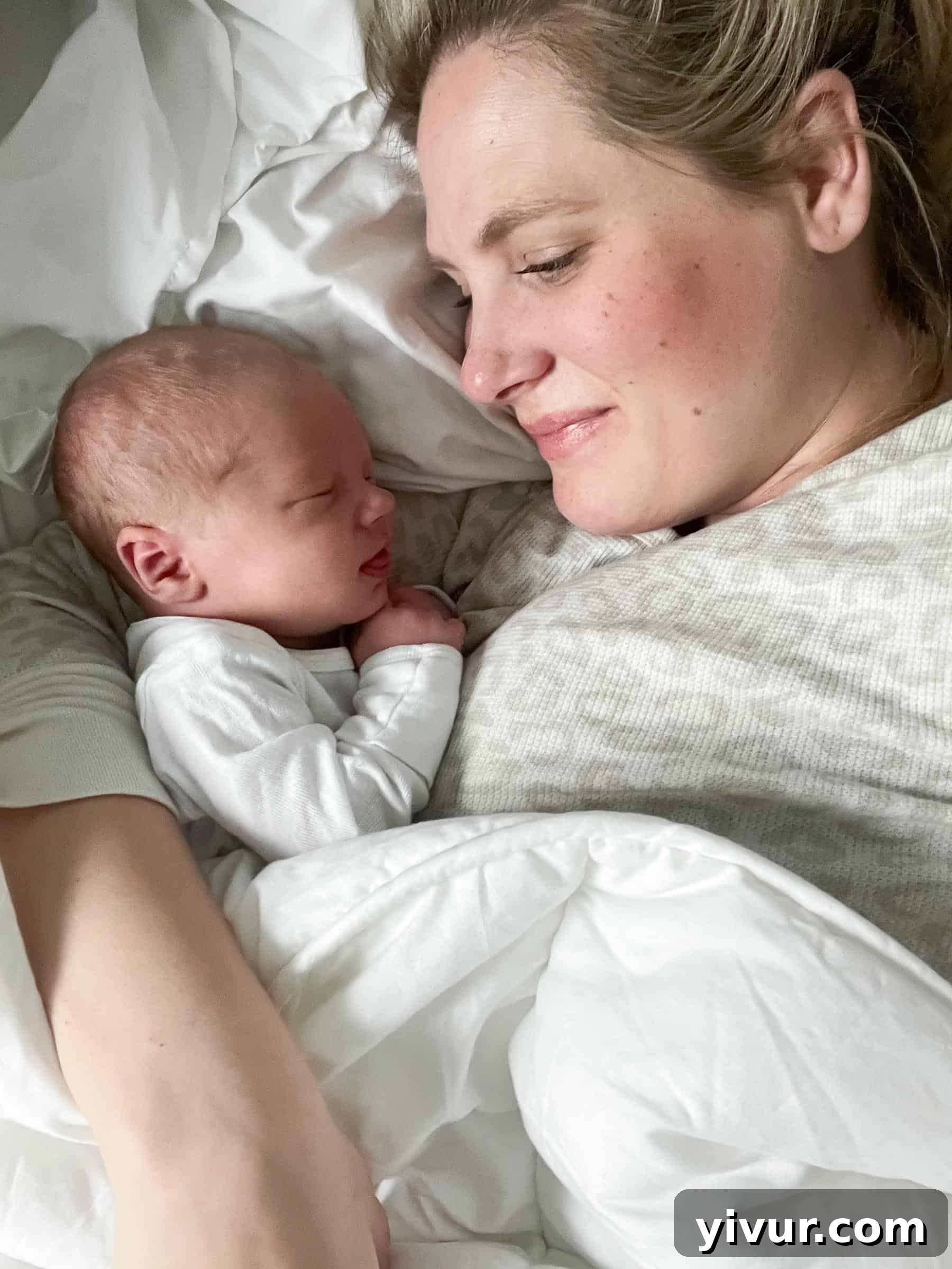 Another precious moment of an older brother engaging with baby Luke, perhaps a gentle touch or a loving gaze, demonstrating sibling bonding.