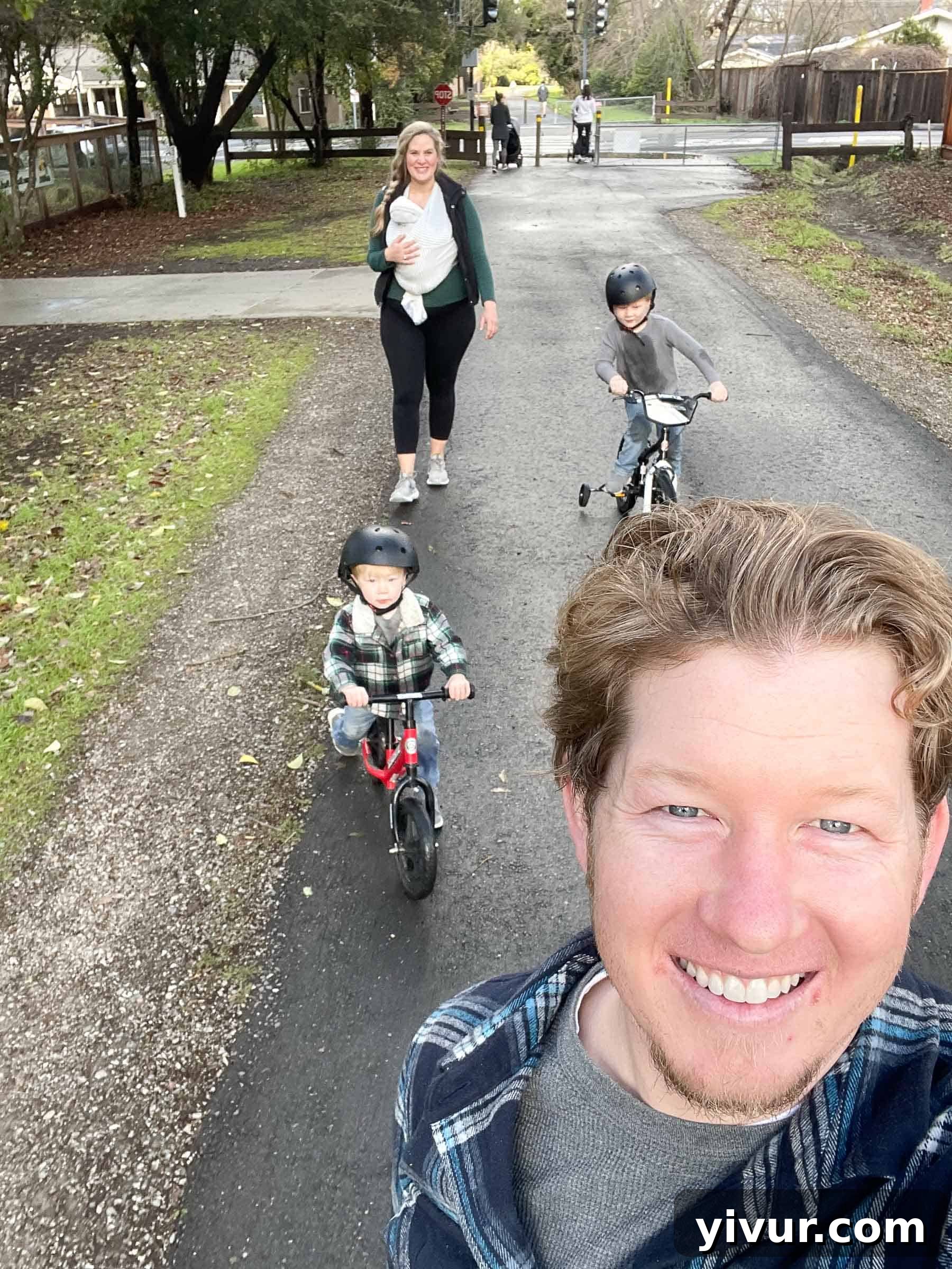 A family snapshot showing a wider view of the family interacting with Luke, capturing the joyous atmosphere of their home with the new baby.