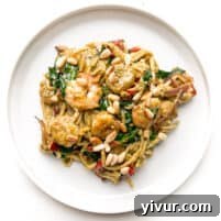 pesto shrimp pasta on a white plate